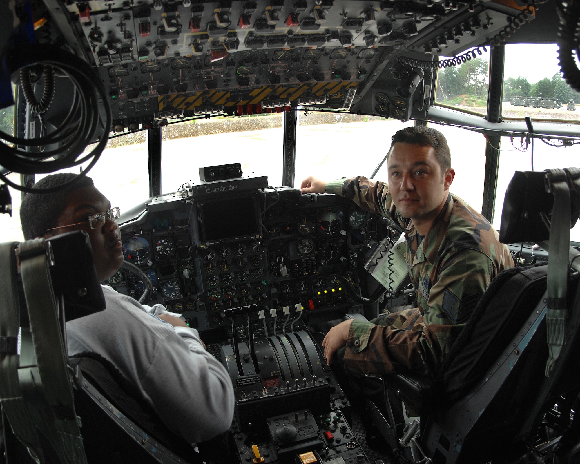 Staff Sgt. Nicholas Sawchak, 86th Aircraft Maintenance Squadron, shows Jordan Perry all the ins and outs of a C-130 July 21, 2007.  Jordan, who recenlty beat cancer, had the wish to visit Ramstein Air Base. Jordan's dad, Lester Perry, a retired first sergeant, was stationed in Germany in the early 90's. Ramstein Air Base personnel from different squadrons and the Dreams Come True foundation pulled together to make Jordan's dream a reality. (U.S. Air Force Photo/A1C Kenny Holston) 
