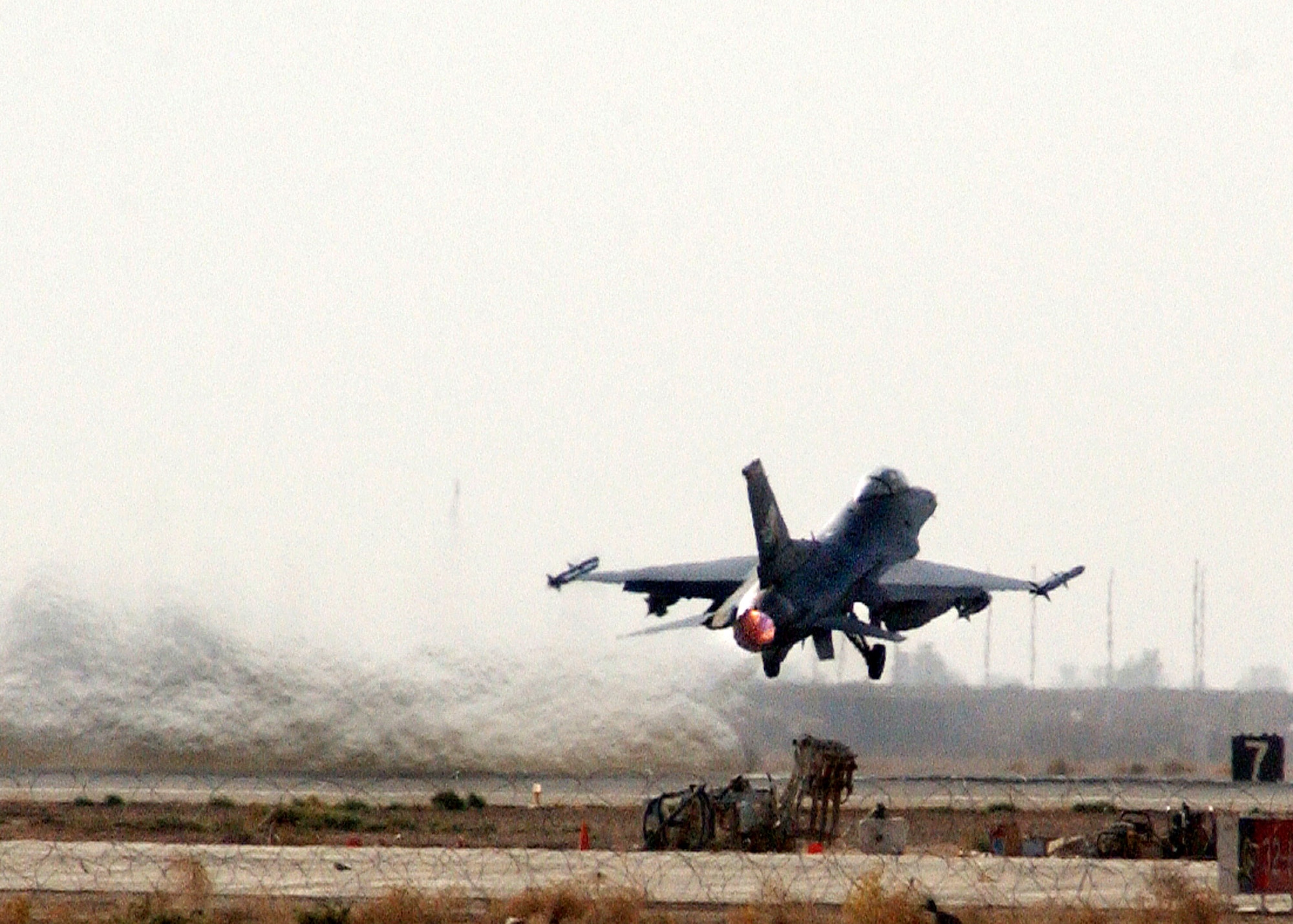 An F-16 Fighting Falcon takes off for a combat mission in support of Operation Iraqi Freedom July 22 at Balad Air Base, Iraq. The two F-16s are deployed from the Oklahoma Air National Guard's 138th Fighter Wing at the Tulsa International Airport. F-16s from the 332nd Air Expeditionary Wing destroyed an al-Qaida training camp southwest of Baghdad July 21. (U.S. Air Force photo/Senior Airman Olufemi A. Owolabi) 
