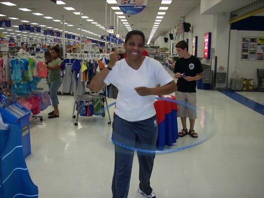 Laraine Warren-Dawn, senior master sergeant and superintendent of the 917th Services Flight, competes in a hula hoop contest at the base exchange Wednesday, July 25. The contest was one activity held for the 112th birthday celebration of the base exchange program. Sergeant Warren-Dawn placed second. (U.S. Air Force courtesy photo)