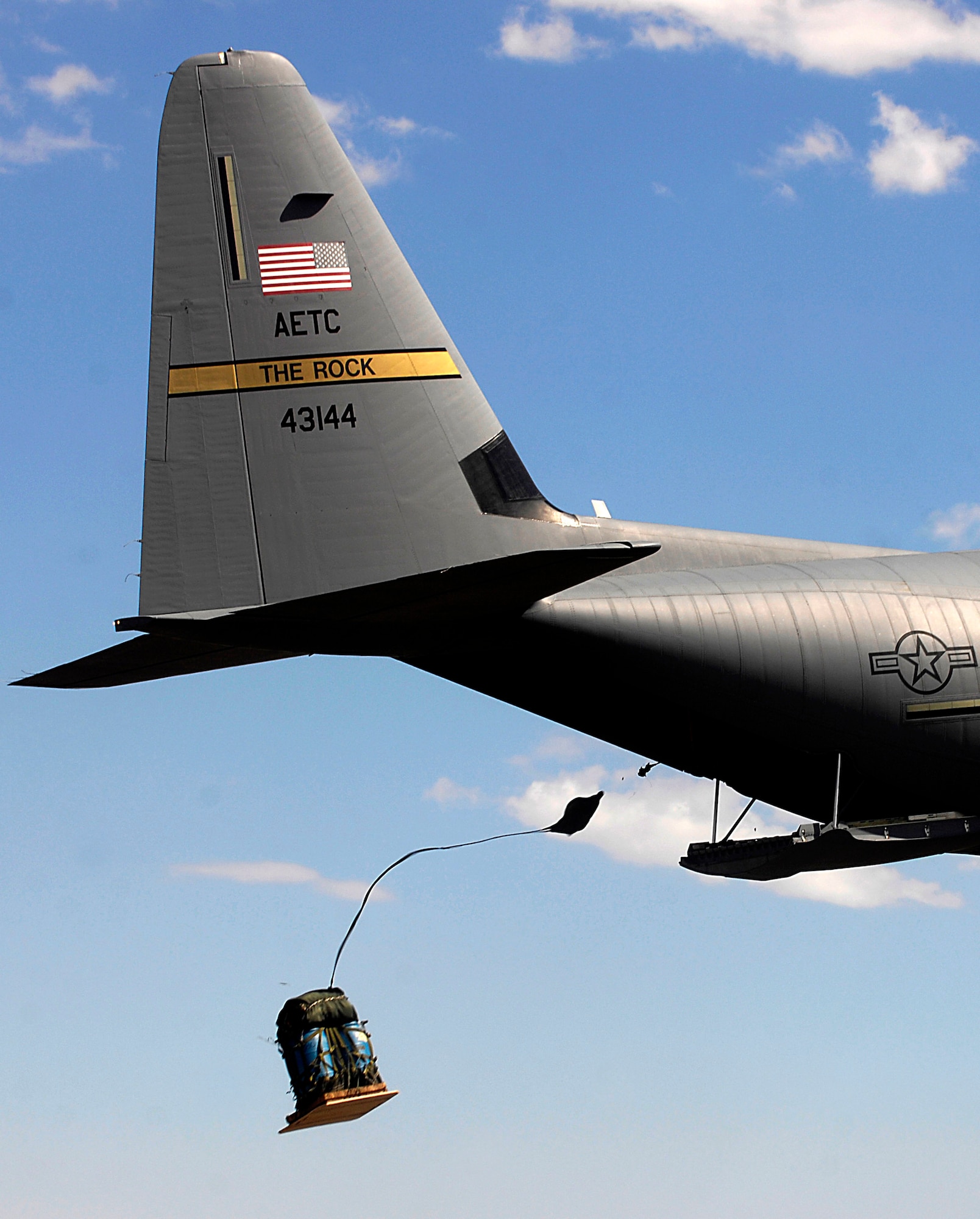 A C-130J Hercules from the 314th Airlift Wing at Little Rock Air Force Base, Ark., competes in the air drop competition for Air Mobility Rodeo 2007 by dropping pallets on targets July 23.  Rodeo is a readiness competition for U.S. and international mobility air forces.  (U.S. Air Force photo/Staff Sgt. Richard Rose) 