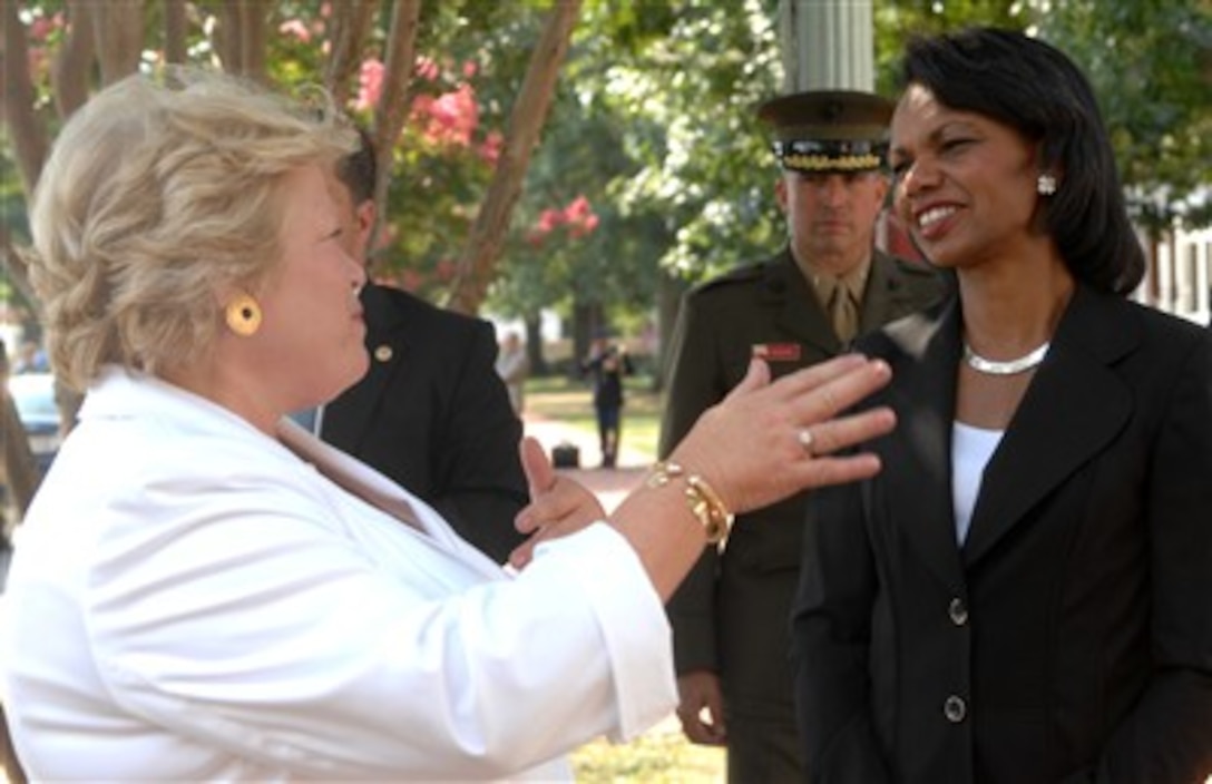 Mrs. Cynthia Giambastiani, wife of Vice Chairman of the Joint Chiefs of Staff, Adm. Edmund P. Giambastiani, talks with Secretary of State Condoleeza Rice before the admiral's retirement ceremony at the U.S. Naval Academy at Annapolis, Md., July 27, 2007. 