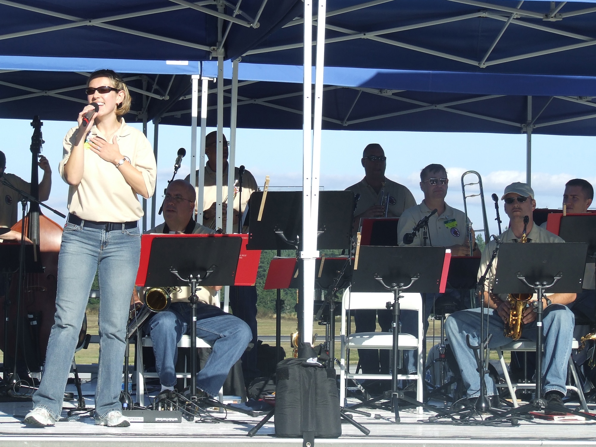 Airman 1st Class Rachel Trimble, Air Mobility Command Band of the Golden West, Travis Air Force Base, Calif., sings on stage at "Rainier Ranch" for Air Mobility Rodeo 2007 at McChord AFB, Wash., July 24.  The band played for Rodeo throughout the week for Rodeo events.  (U.S. Air Force Photo/Tech. Sgt. Scott T. Sturkol)