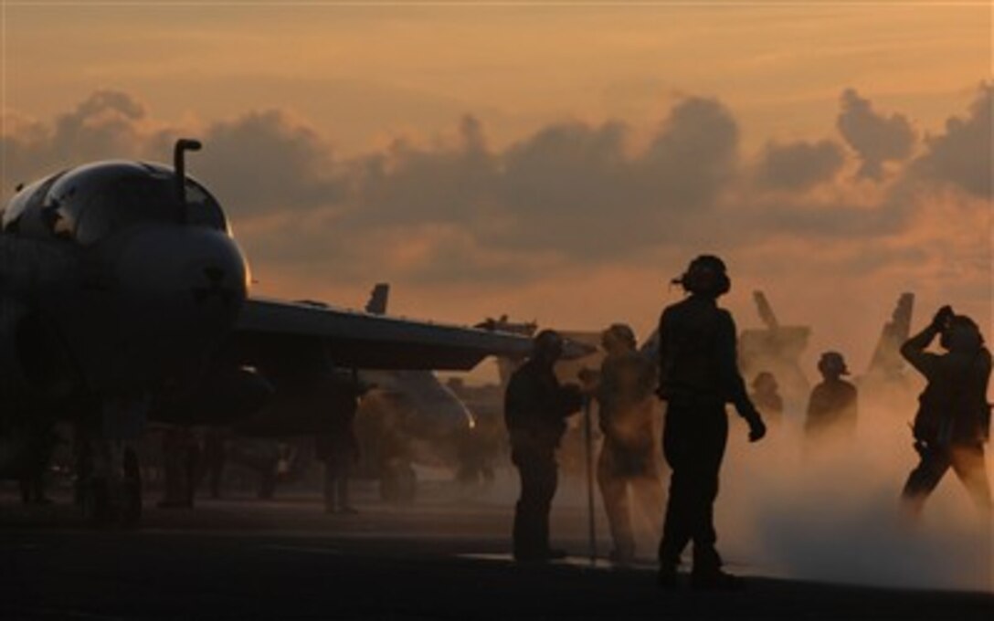 An EA-6B Prowler aircraft from the "Yellow Jackets" of Electronic Attack Squadron One Three Eight is directed onto the catapult as it prepares to launch off the flight deck of the Nimitz-class aircraft carrier USS John C. Stennis while under way in the Pacific Ocean, July 25, 2007.