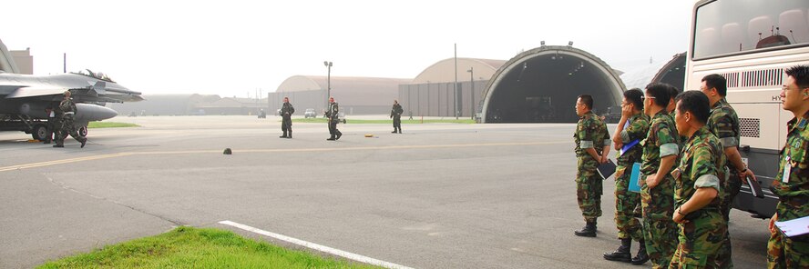 OSAN AIR BASE, Republic of Korea -- Republic of Korea Air Force members observe how United States Air Force operate on the flightline during the Beverly Bulldog 07-03 exercise here on July 25, 2007. The exercise Beverly Bulldog 07-03 scenarios test Team Osan's ability to defend the base and conduct daily operations in a combat environment. (U.S. Air Force photo by Airman 1st Class Chad Strohmeyer) (Released)