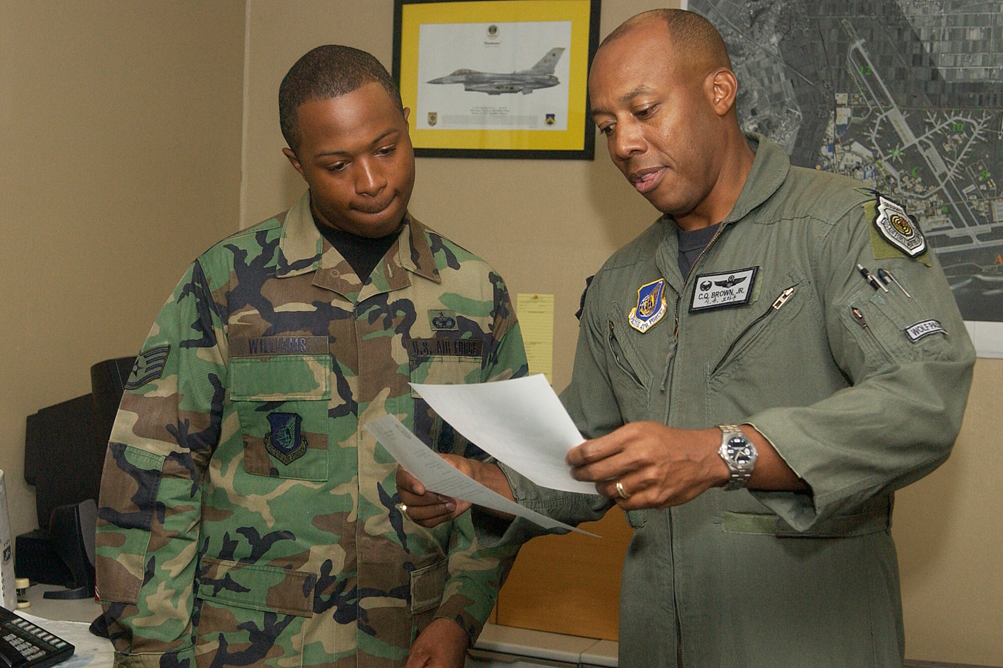 KUNSAN AIR BASE, Republic of Korea -- Col. CQ "Wolf" Brown, 8th Fighter Wing commander, reads a letter of congratulations to Staff Sgt. Markeith Williams, 8th Security Forces NCOIC of resource protection. Sergeant Williams was selected as the Wolf Pack's pride of the pack for the week of July 9. (U.S. Air Force photo/Senior Airman Giang Nguyen)                             