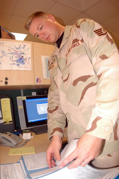 SOUTHWEST ASIA - Staff Sgt. Ryan Johnson, 379th Expeditionary Contracting Squadron contingency contracting officer, reviews contracting documents to ensure it has been completed properly. Sergeant Johnson is a native of Danville, Ill. and is deployed from Seymour Johnson Air Force Base, N.C. (U.S. Air Force photo/Senior Airman Clark Staehle) 