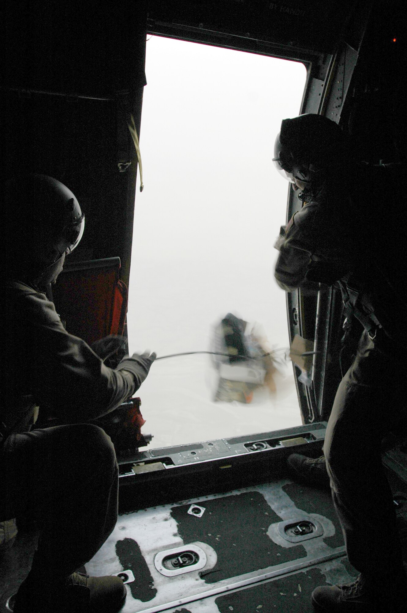 Master Sgt. Larry Lambert, 746th Expeditionary Airlift Squadron senior loadmaster and Senior Airman Ronald Orr, 746th EAS mission loadmaster release one box of leaflets over Afghanistan. The squadron successfully met their objective of dropping 120,000 leaflets, prepping the battlefield for future operations.(U.S. Air Force photo by Capt. Teresa Sullivan)