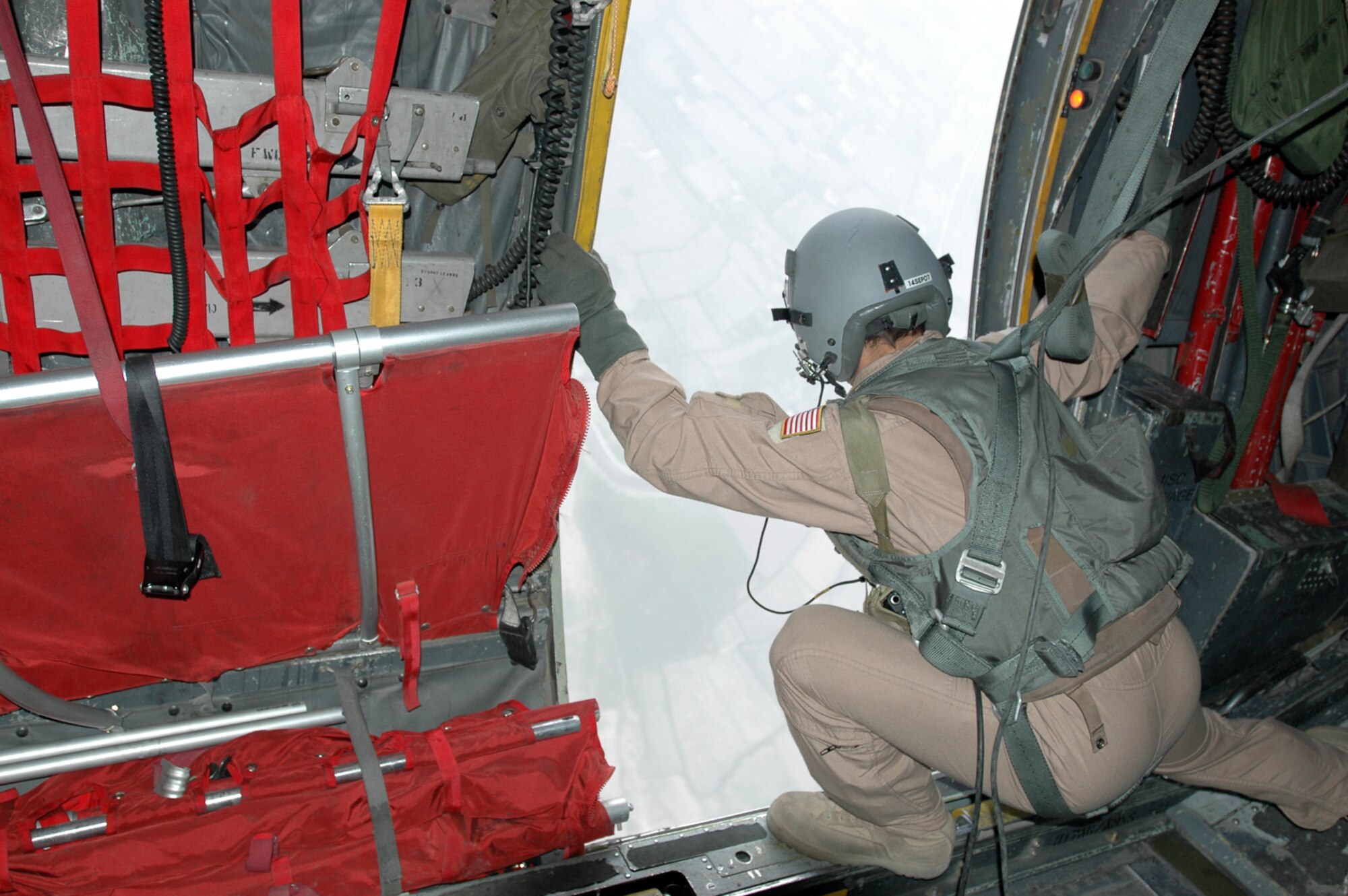 Tech. Sgt. Matt Rossi, 746th Expeditionary Airlift Squadron instructor loadmaster, drops 30,000 leaflets over a drop zone in the Helmand Province, Afghanistan July 22.(U.S. Air Force photo by Capt. Teresa Sullivan)