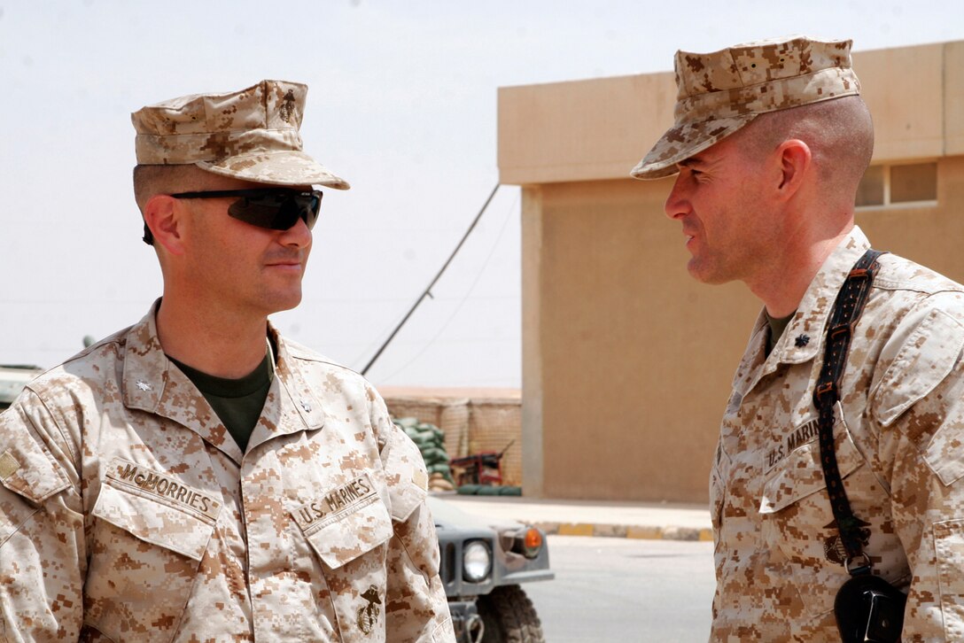 CAMP AL QA?IM, Iraq ? Lt. Col. David McMorries, the deputy communications officer with Multinational Forces West is greeted by Lt. Col. Jason Q. Bohm, the Task Force commander for Task Force 1st Battalion, 4th Marines attached to Regimental Combat Team 2.  McMorries came to Al Qa?im to visit his son, Lance Cpl. Brennan McMorries, a rifleman with Charlie Company.