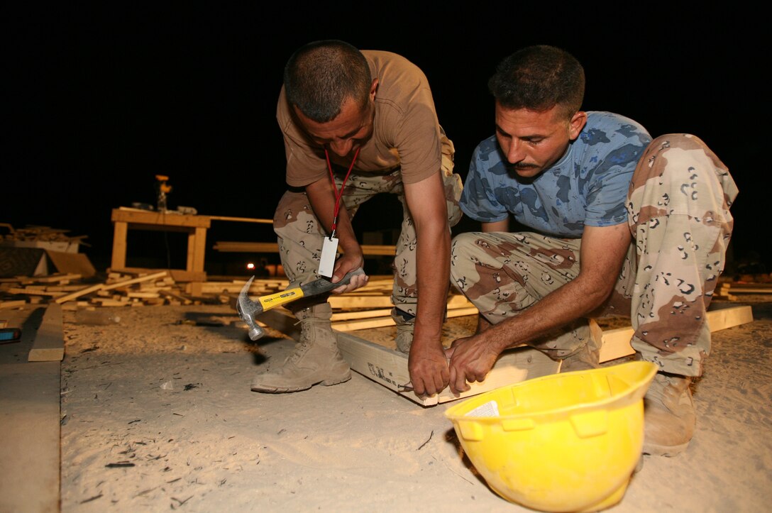 AL TAQADDUM, Iraq (July 30, 2007) ? Iraqi army engineers prefabricate walls for structures here July 30.  The walls will be used for buildings at a combat outpost in Al Anbar province?s Thar Thar region.  The Marines of 8th Engineer Support Battalion, 2nd Marine Logistics Group (Forward) taught and helped the Iraqi engineers prefabricate the materials for structures to be occupied by Iraqi security forces.