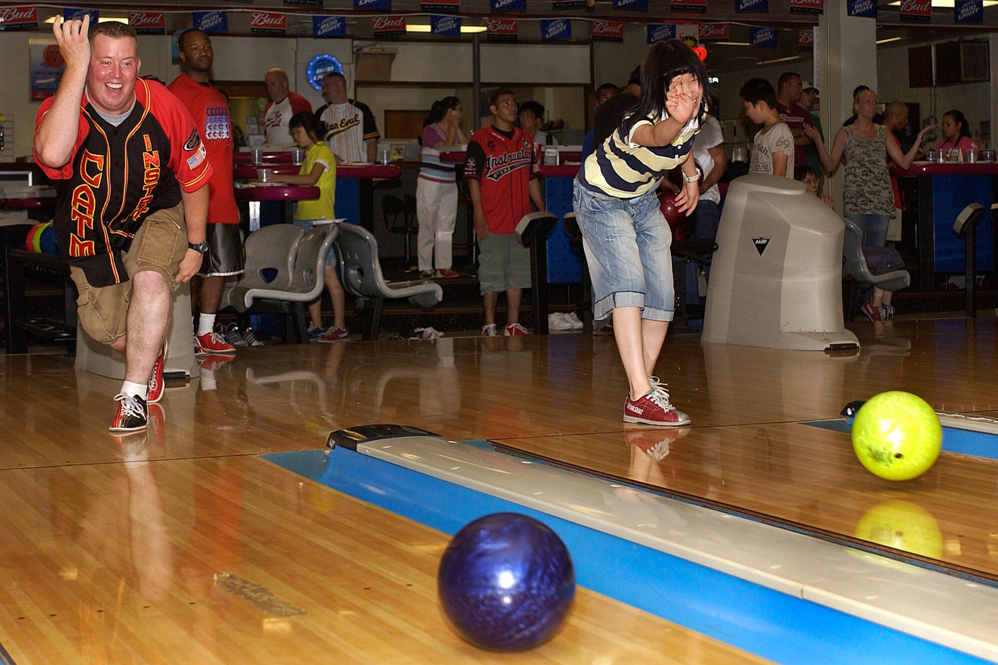 KUNSAN AIR BASE, Republic of Korea -- Staff Sgt. Brian Caudill, 8th Security Forces Squadron and Song Hwa Chae enjoy bowling July 30 here. The 8th SFS hosted a bowling event with 17 children from a Gunsan City orphanage. (U.S. Air Force photo/ Senior Airman Giang Nguyen)

                               