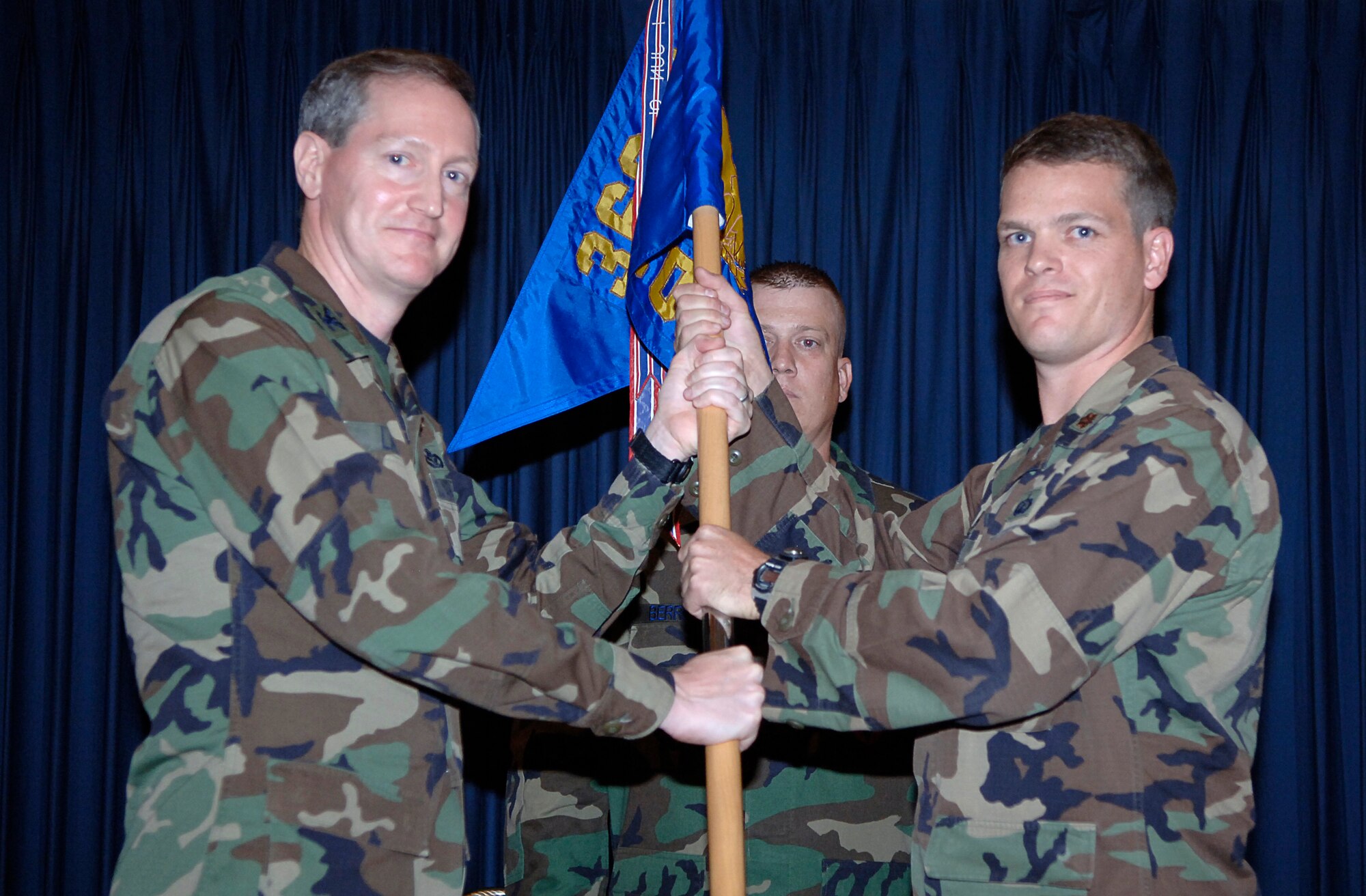 MOUNTAIN HOME AIR FORCE BASE, Idaho -- From left, Col. Thomas Laffey, 366th Mission Support Group commander, passes the 366th Contracting Squadron guidon to Major Colten Pond, the squadron’s new commander, at a change of command ceremony July 27. Major Pond came here after serving as the special program procurement manager at Macdill Air Force Base, Fla. Lt. Col. Andrew Sackett, the outgoing commander, will remain at the base until Sept. 4 as the 366th MSG deputy commander. He will then go to Shaw Air Force Base, S.C. to serve as the U.S. Central Command chief of contracting. (U.S. Air Force photo/Airman 1st Class Ryan Crane)