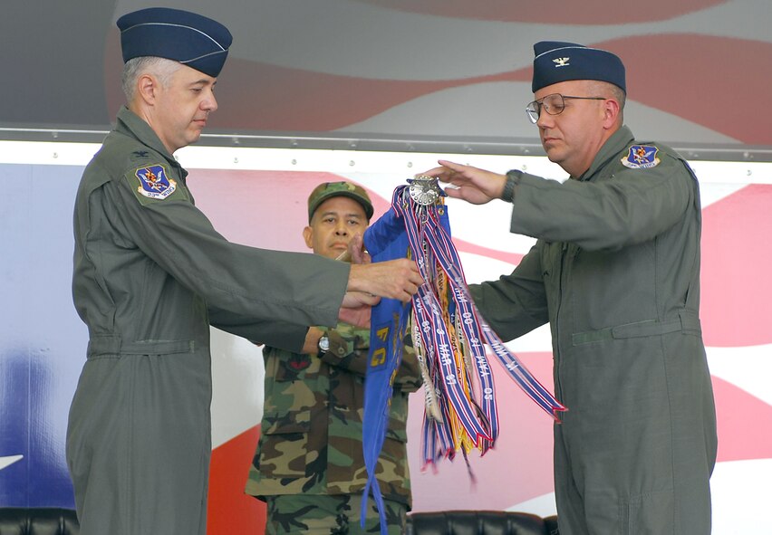 Col. Kenneth Todorov, 23rd Wing commander, and Col. Michael O'Dowd, 23rd Fighter Group commander, unfurl the 23rd FG flag at the unit's welcoming ceremony July 30. The 23rd FG is preparing to permanently settle into Moody in the upcoming weeks. (U.S. Air Force photo by Senior Airman Angelita Lawrence)