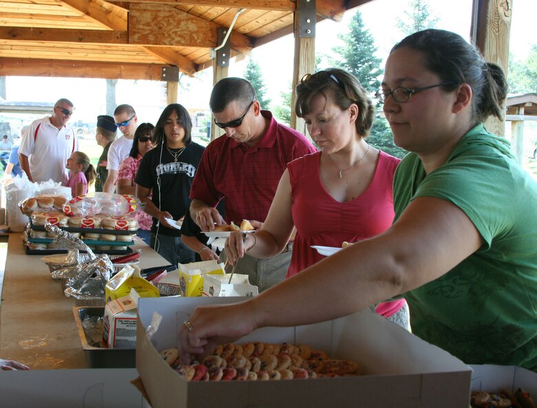 Team Malmstrom members line up for some free food at the "Cruisin' the Summer" base picnic July 27. More than 2,500 people attended the annual barbeque at Malmstrom Air Force Base, Mont., which is sponsored annually by the 341st Services Squadron with help from local businesses.  (U.S. Air Force photo/Senior Airman Eydie Sakura).