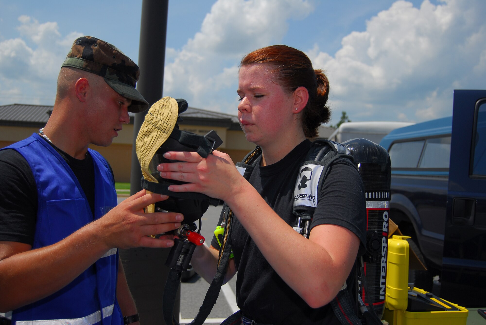 Airman 1st Class Sarah Cox, 23rd Medical Group bio-environmental specialist, prepares to enter a “hot zone” in a protective suit to sample an unknown substance.  She is being assisted by Senior Airman Shawn Gatten, another 23rd MDG bio-environmental specialist.  The two were participating in a base medical readiness exercise July 26 to test the wing's disaster preparedness.  (U.S. Air Force photo by Tech. Sgt. Parker Gyokeres)