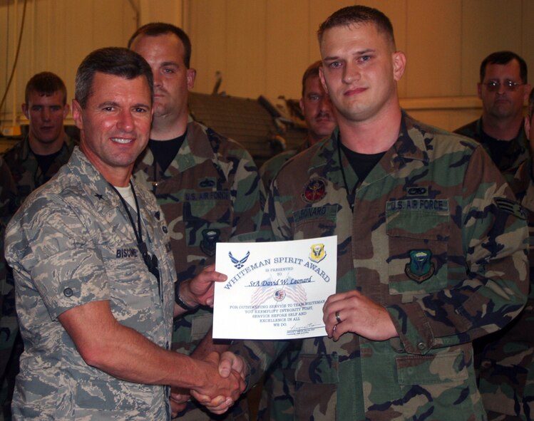 WHITEMAN AIR FORCE BASE, Mo. -- Left to right: Senior Airman David Leonard, 509th Maintenance Squadron, receives the Whiteman Spirit Award from Brig. Gen. Greg Biscone, 509th Bomb Wing commander, July 30. (U.S. Air Force Maj. Joe DellaVedova)