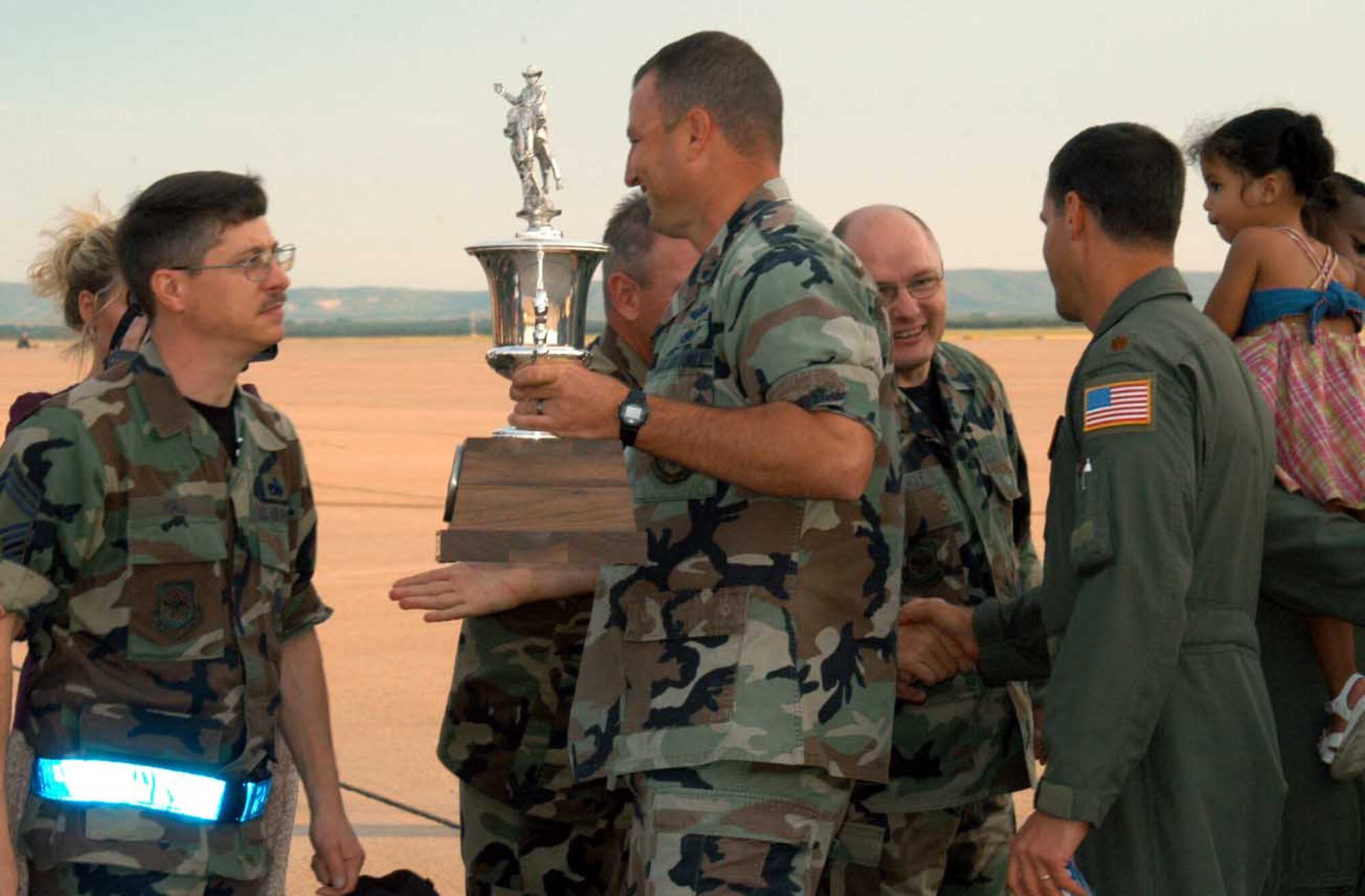 Chief Master Sgt. Michael Hall, 317th Aircraft Maintenance Squadron, welcomes 1st Lt. Daryl Cesal, 317th AMXS, back to Dyess after the 2007 Air Mobility Command Rodeo July 28. Lieutenant Cesal and the 21 other Team Dyess members brought back trophies for best C-130/C-160 and best C-130/C-17 airdrops, worldwide. (U.S. Air Force photo/Senior Airman Carolyn Viss)                            