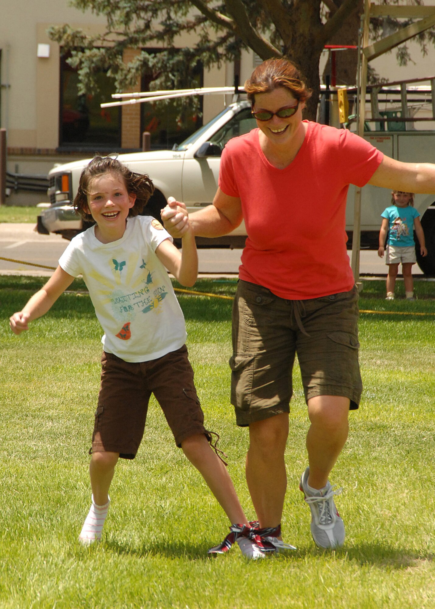 Alexandria Moore, 8 years old, and her mother Becky Moore get into the summer fun with a 3-legged race at this year?s Summer Bash, July 20, at Hardin Field.  U.S. Air Force photo by Todd Berenger


