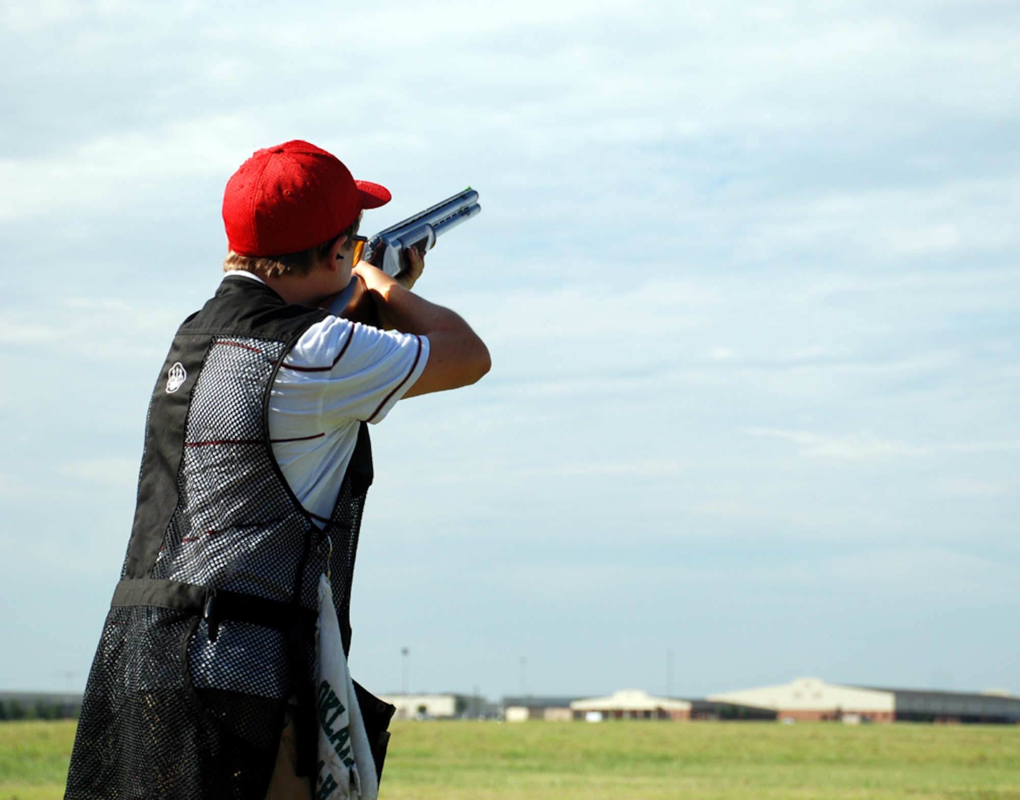 Logan Hukill takes aim at the National Skeet Shooting Association Tournament at the base shooting range July 28. Bryan Davis, 15-year-old son of Lt. Col. Rick Davis, 88th Flying Training Squadron commander, placed first in the 12 gauge, 20 gauge, 28 gauge and .410 bore class shoots, as well as winning the overall event. The event featured 16 shooters from both Texas and Oklahoma, and was the first of its type held at Sheppard in five years. (U.S. Air Force photo/Airman 1st Class Jacob Corbin) 