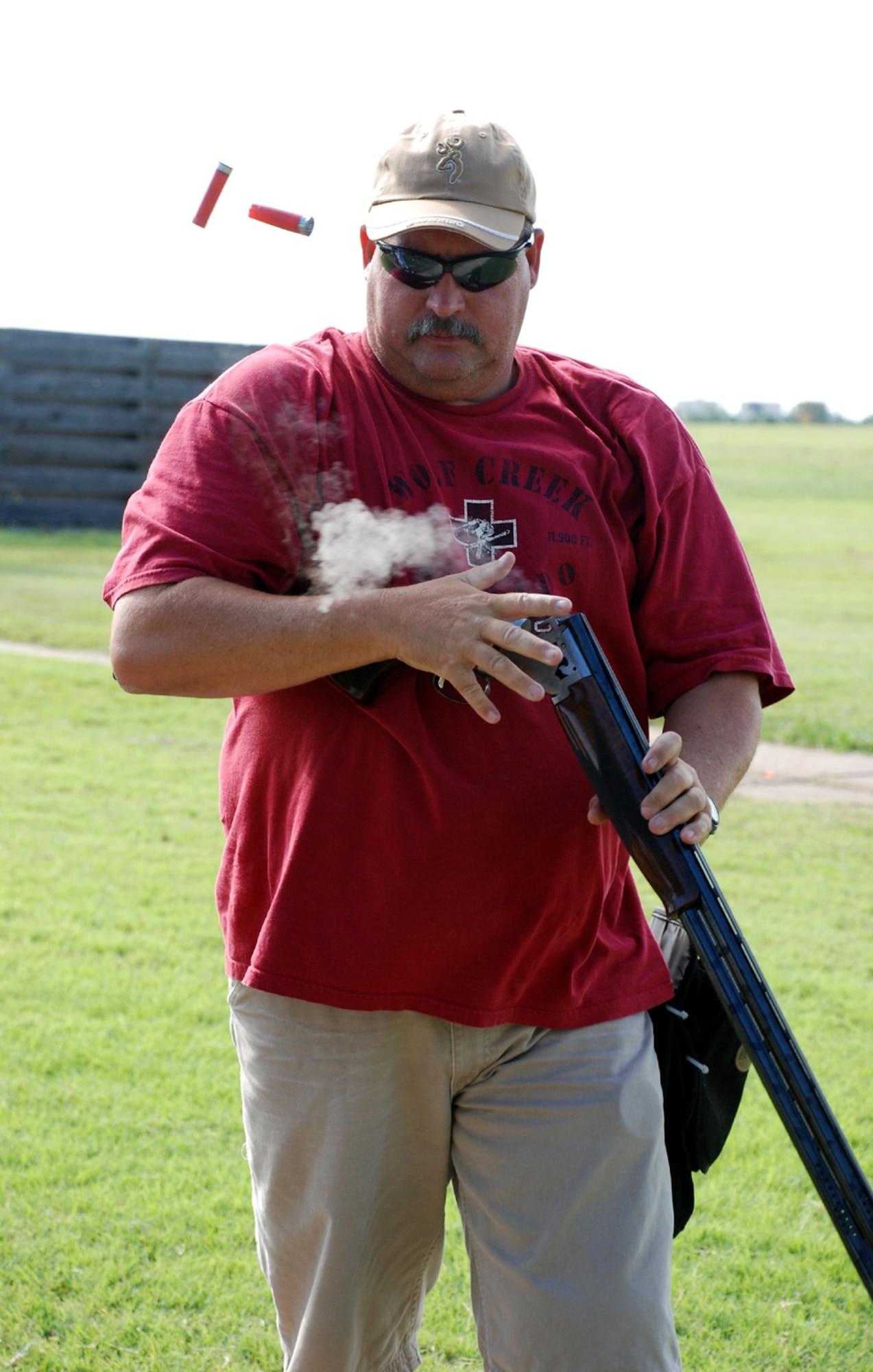 James Hukill unloads his weapon at the National Skeet Shooting Association Tournament at the base shooting range July 28. Bryan Davis, 15-year-old son of Lt. Col. Rick Davis, 88th Flying Training Squadron commander, placed first in the 12 gauge, 20 gauge, 28 gauge and .410 bore class shoots, as well as winning the overall event. The event featured 16 shooters from both Texas and Oklahoma, and was the first of its type held at Sheppard in five years. (U.S. Air Force photo/Airman 1st Class Jacob Corbin) 