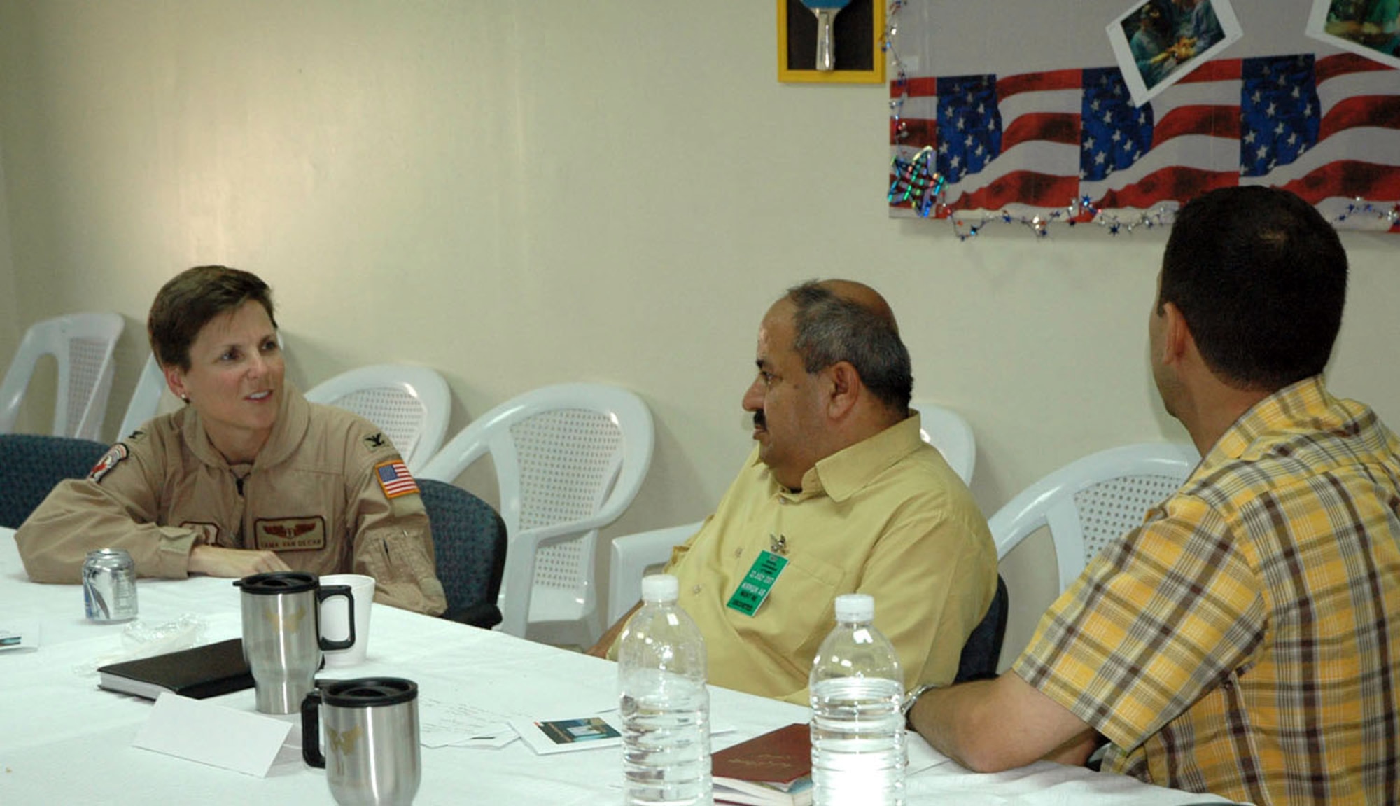 Col. Tama Van Decar, commander of the 506th Expeditionary Medical Squadron, talks with the deputy director general of Kirkuk's Ministry of Health, Dr. Burham, and another local Iraqi physician July 22 during a medical symposium at Kirkuk Regional Air Base, Iraq. The symposium brought eight physicians from downtown to the base to meet with about 20 U.S. Air Force and Army medical providers, and featured discussions on how to transfer Iraqi patients seen on base to downtown hospitals. (U.S. Air Force photo) 