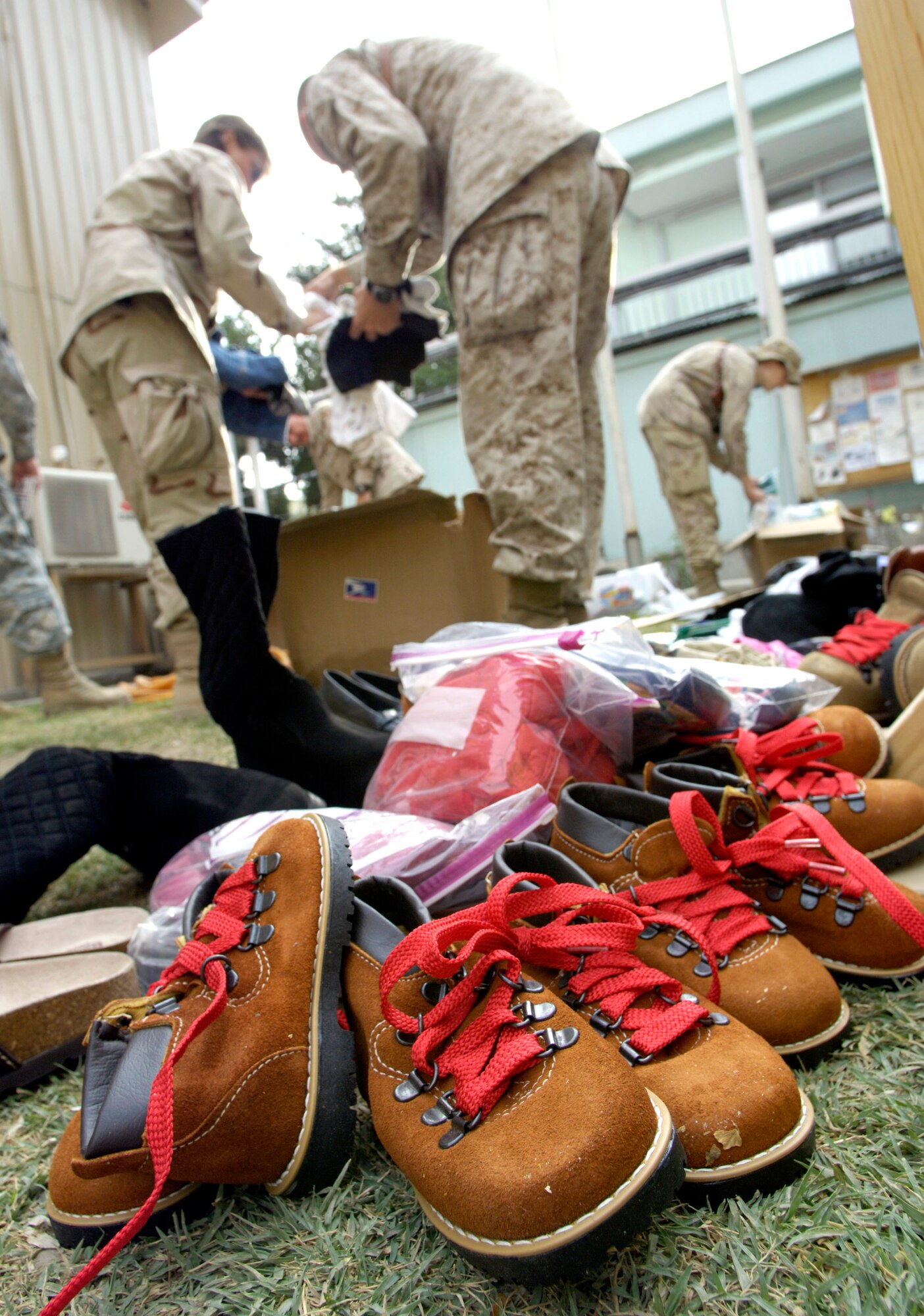 Volunteers from the Combined Security Transition Command-Afghanistan sort donations July 23 sent from the United States to Camp Eggers in Kabul, Afghanistan. The volunteers, made up of joint and international military members, civil servants and contractors from throughout the CSTC-A, gather every two weeks to sort and package the clothing, toys, school supplies and toiletries which will be distributed in the Kabul area. (U.S. Air Force photo/Master Sgt. Jim Varhegyi)