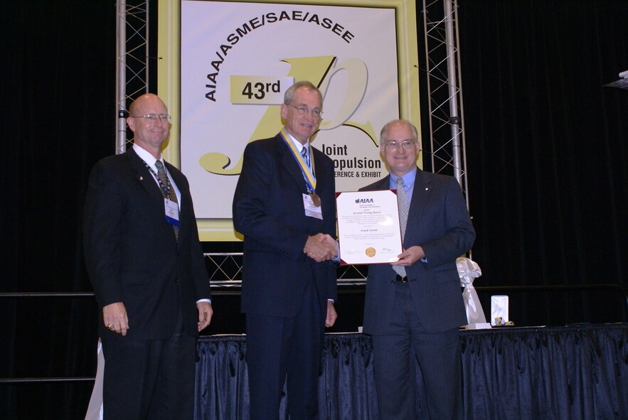(From right) Paul Nielsen, American Institute of Aeronautics and Astronautics (AIAA) president, presents Arnold Engineering Development Center's Frank Steinle with the 2007 AIAA Ground Testing Award while John Blanton, with General Electric Aviation and the conference chairman, looks on during the 43rd Joint Propulsion Conference in Cincinnatti, Ohio. (Photo by Philip Lorenz III)
