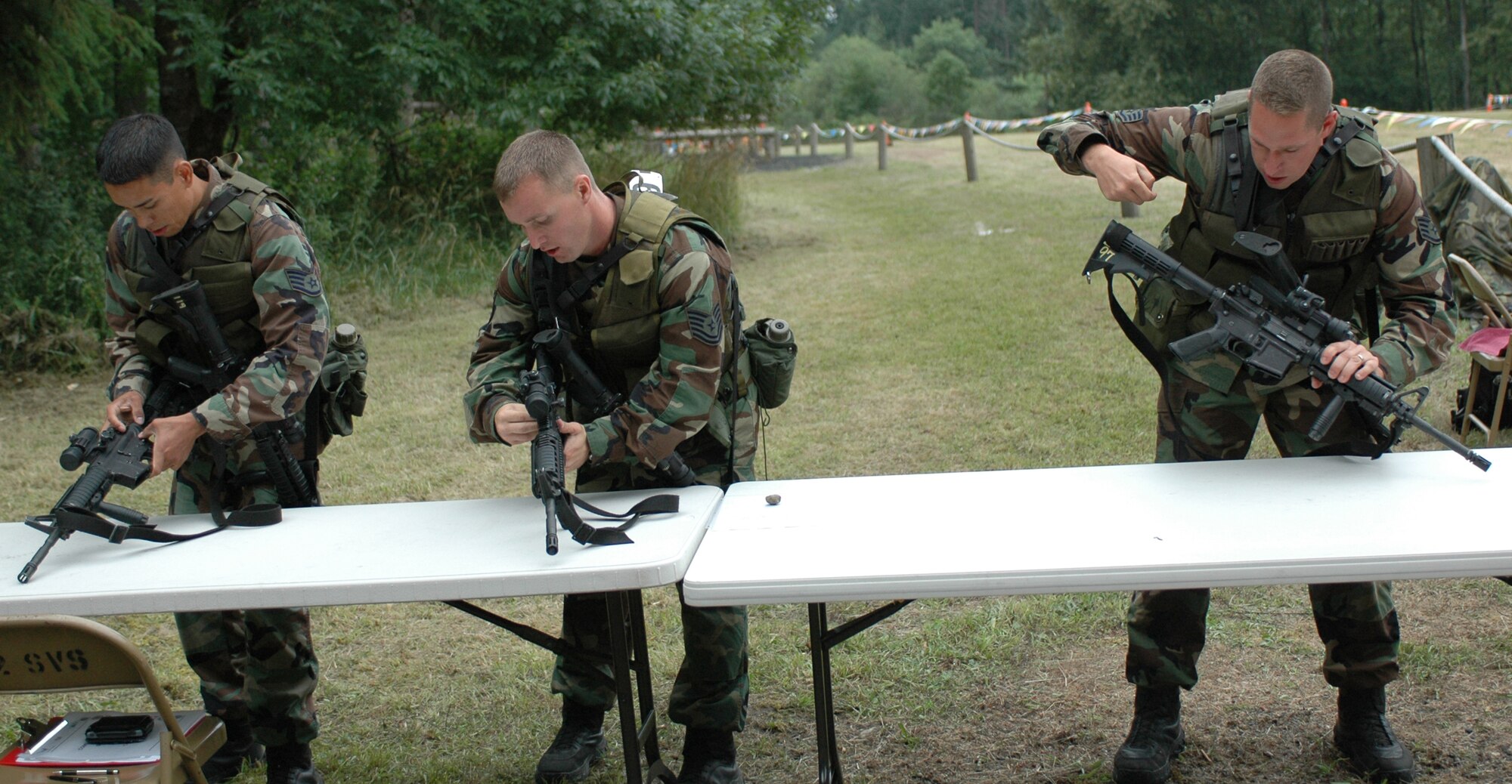 The 60th Security Forces rodeo team assembled weapons during the first part of the combat challenge course July 26 at McChord Air Force Base, Wash. The course also featured a 1.5 - mile run in full gear and a litter carry before the team sprinted to the finish line. (U.S. Air Force photo/Airman 1st Class Kristen Rohrer)