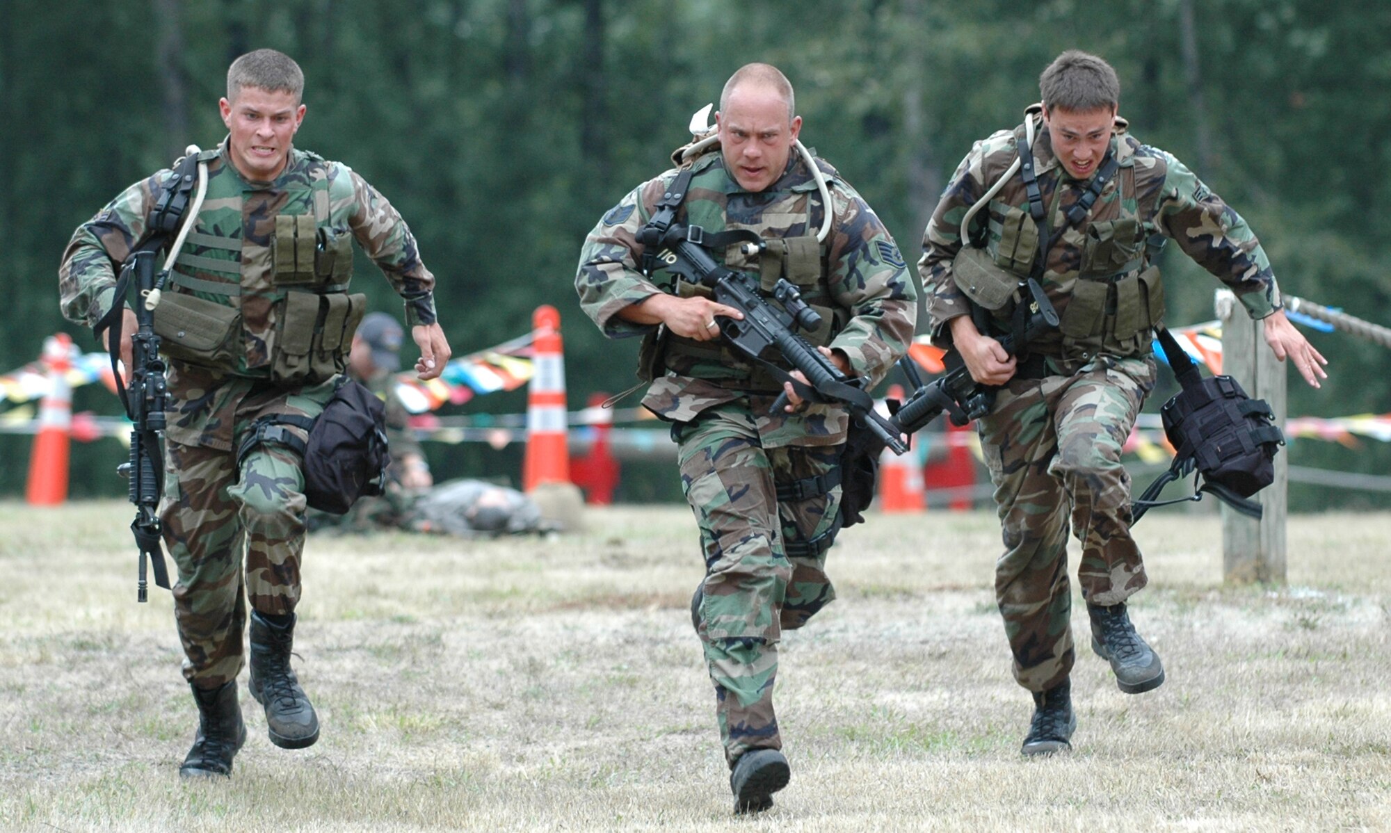 The 615th Contingency Response Wing security forces team sprints to the finish line during the combat challenge course July 26 at McChord Air Force Base, Wash. The course featured weapons assembly, a 1.5 mile run in full gear and a litter carry of a wounded patient. (U.S. Air Force photo/Airman 1st Class Kristen Rohrer)