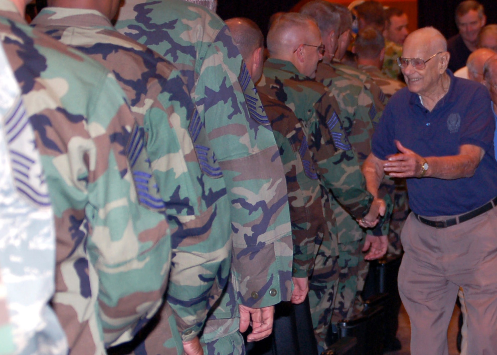 Chief Master Sgt. of the Air Force Paul Wesley Airey shakes the hands of senior enlisted leaders as he departs the auditorium at the Air Force Senior NCO Academy July 26 at Maxwell Air Force Base's Gunter Annex, Ala. Chief Airey, the first chief master sergeant of the Air Force, sat on the Chief Master Sergeant of the Air Force Panel where he discussed issues affecting Airmen during the Senior Enlisted Leader Summit. (U.S. Air Force photo/Master Sgt. Lee Roberts) 
