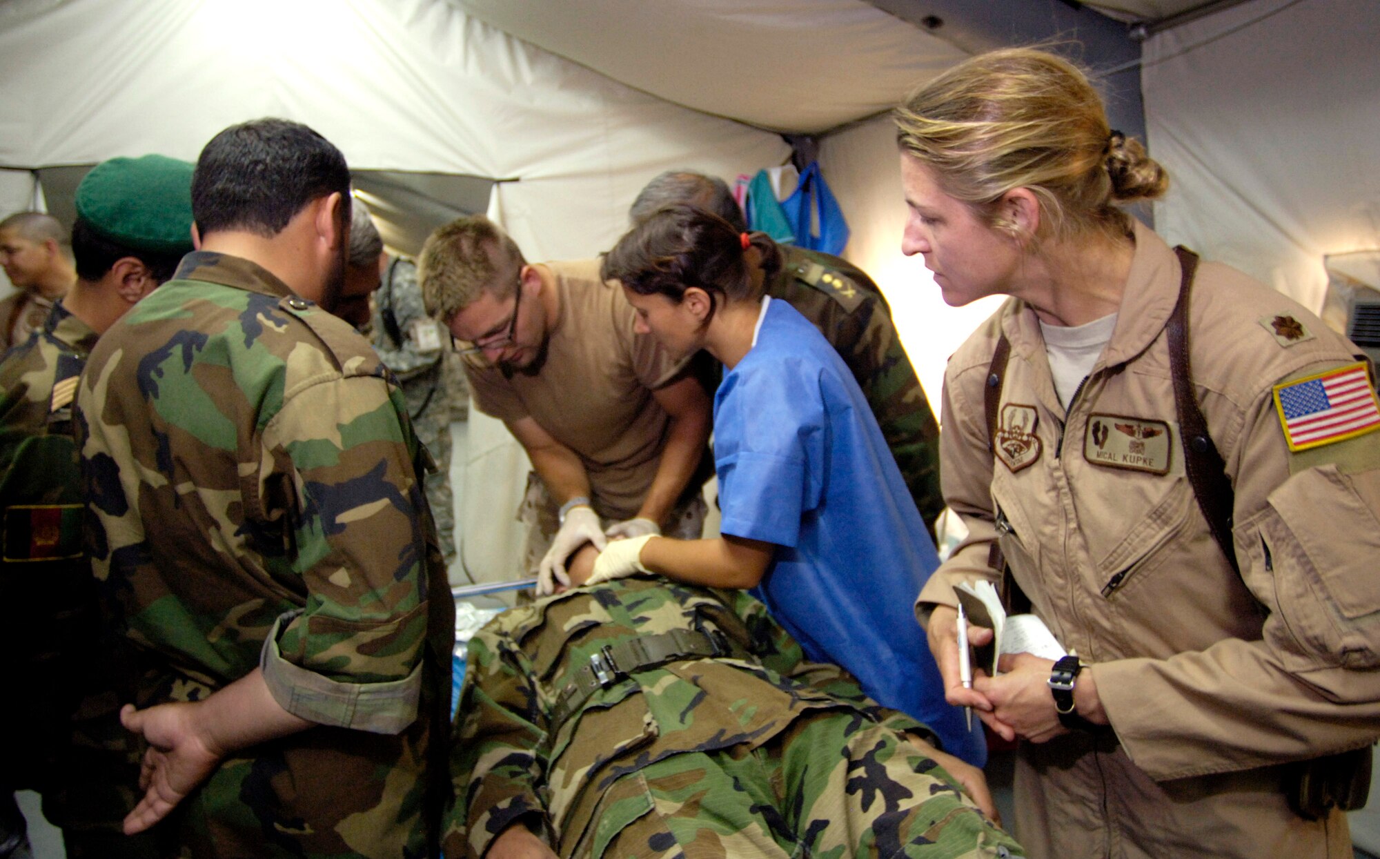 Maj. Mical Kupke observes as an emergency medical technician from the Czech Republic demonstrates how to open an airway to members of the Afghan National Army air corps July 25 at Kabul International Airport in Afghanistan. Major Kupke serves as an Air Force mentor and is assigned to the Combined Security Transition Command-Afghanistan with headquarters on Camp Eggers, Kabul, Afghanistan. (U.S. Air Force photo/Master Sgt. Jim Varhegyi)