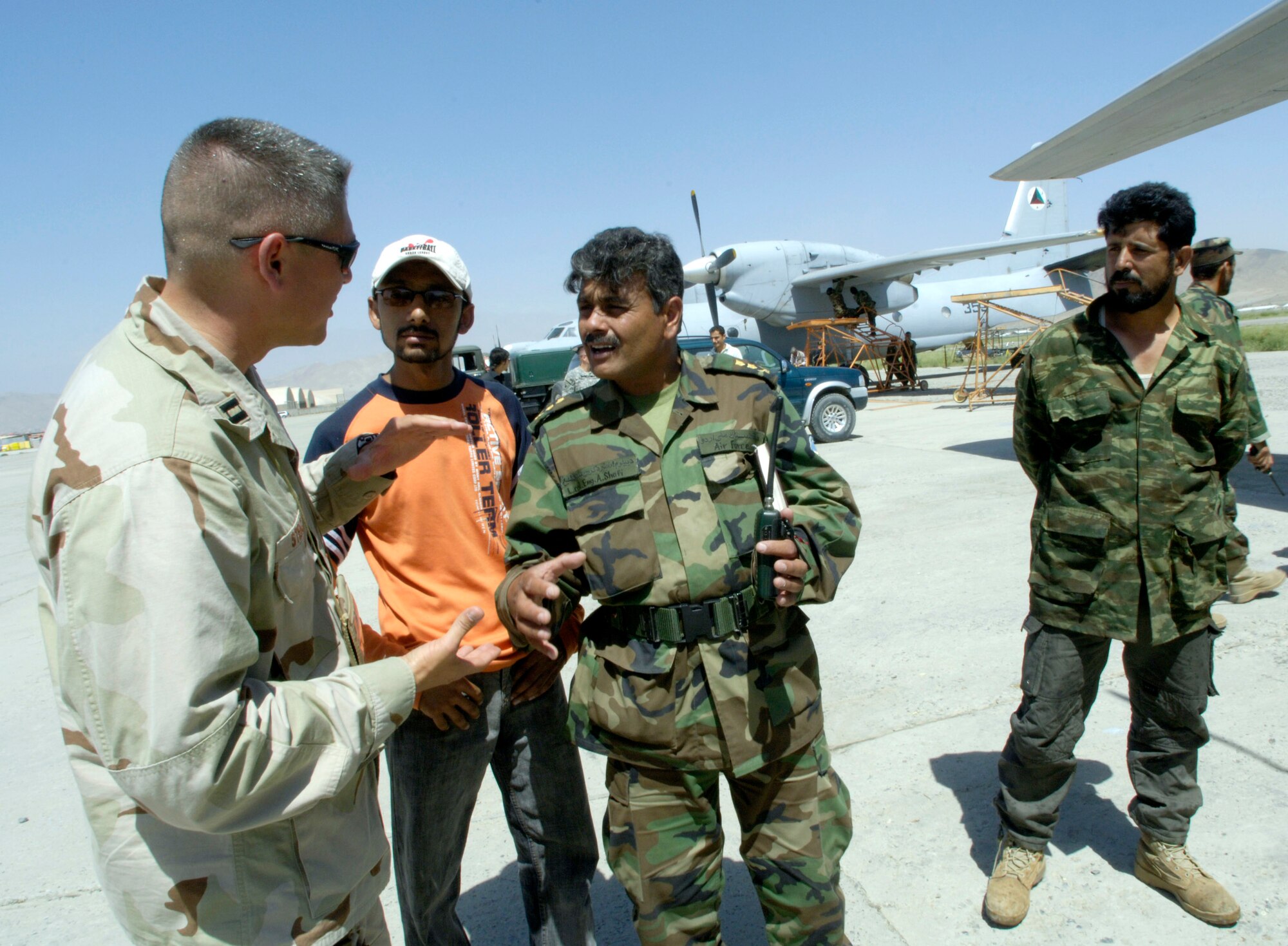 Capt. Ronald Stencel talks maintenance issues with Lt. Col. Abdul Shafi of the Afghan National Army air corps July 25 at Kabul International Airport in Afghanistan.  Colonel Shafi is the ANA air corps senior aircraft maintenance engineer operations group commander. Captain Stencel, deployed from Dover Air Force Base, Del., serves as an Air Force mentor and is Colonel Stafi's senior aircraft maintenance advisor. He is assigned to the Combined Security Transition Command-Afghanistan with headquarters on Camp Eggers, Kabul, Afghanistan. (U.S. Air Force photo/Master Sgt. Jim Varhegyi)