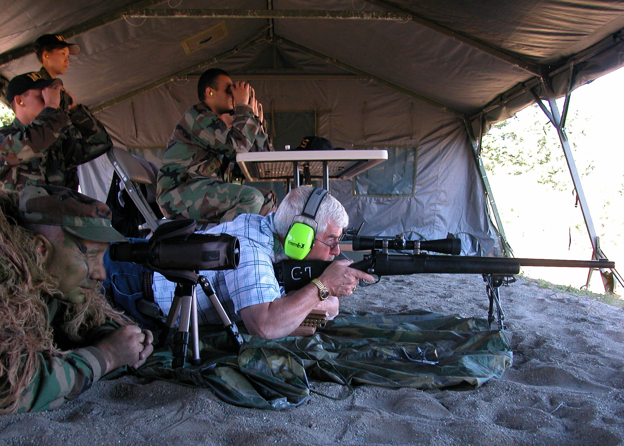 FORT LEWIS, Wash., -- Mr.  Hal Job, Grissom Community Council member, fires the M24 rifle while being spotted by an Air Force sharpshooter during a visit to the Air Mobility Command Rodeo at McChord AFB., Wash. Members of the 434th Security Forces Squadron competed in the event along with many Air Force, and international teams. (U.S. Air Force photo/Tech. Sgt. Doug Hays)