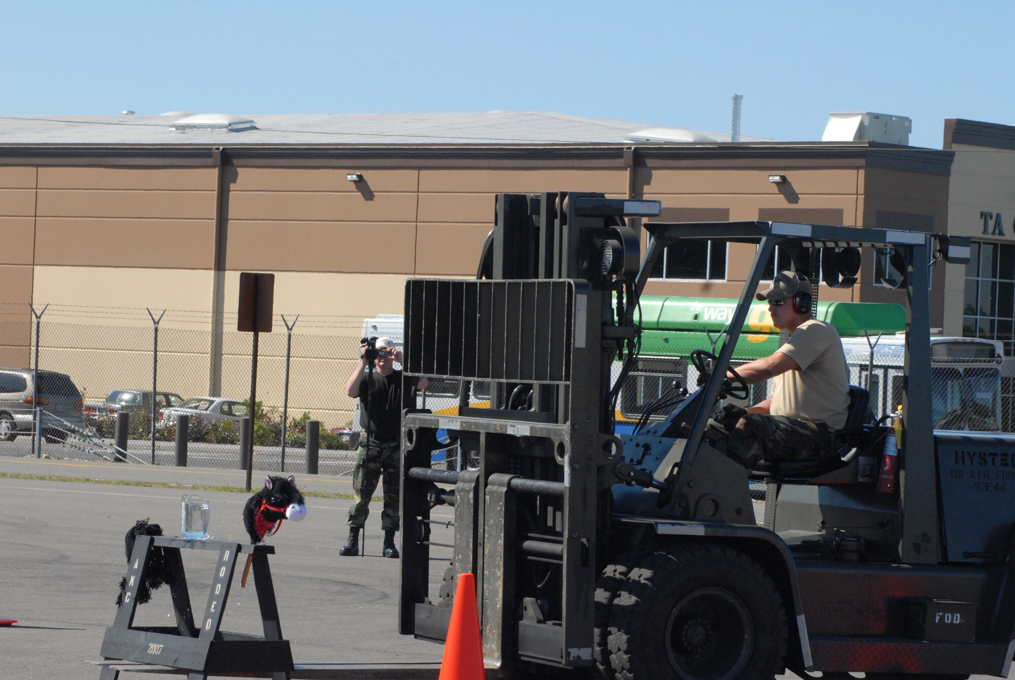 Staff Sgt. Robert Skeels, 2007 Pope Rodeo aerial port team, manuevers a saw horse with a 10K forklift through a series of offset cones July 25 during the Air Mobility Command Rodeo at McChord Air Force Base, Wash. The first portion of this event was to balance speed and technique, as competitors slalomed through the cones trying to spill the least amount of water in the fastest time. (U.S. Air Force photo/Staff Sgt. Jon LaDue)