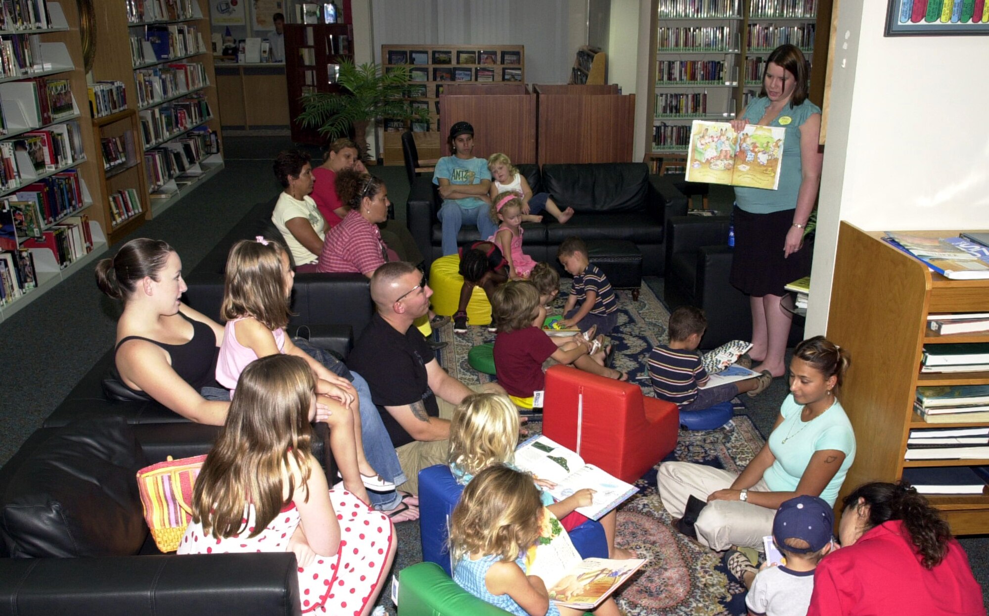 Emily Smilo, 39th Services Squadron librabry technician, reads a book during Story Hour July 27. (U.S. Air Force photo by Staff Sgt. Jeff Nevison) (Released)                          