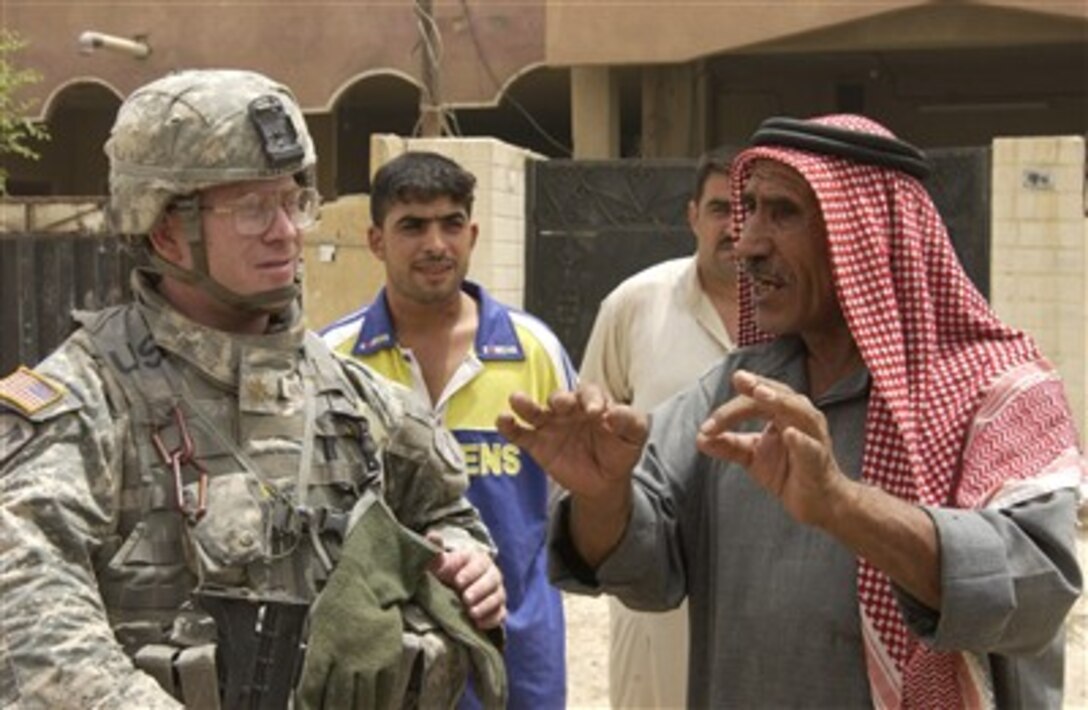 U.S. Army Maj. Ben Hastings, of Charlie Company, 431st Civil Affairs Battalion and attached to the 12th Cavalry Regiment, 2nd Brigade Combat Team, 1st Cavalry Division, speaks with a local national during a humanitarian mission in Haqim, Iraq, July 23, 2007. 