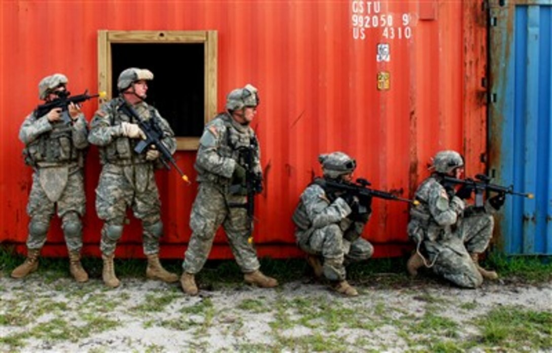 Soldiers from the U.S. Army's Charlie and Delta Company, 1st Battalion, 175th Infantry Regiment, Maryland Army National Guard, combine efforts during a joint urban cordon and search exercise in the mock city of Balad at Fort Dix, N.J., on July 24, 2007.  The soldiers are preparing for a scheduled deployment to Iraq.  