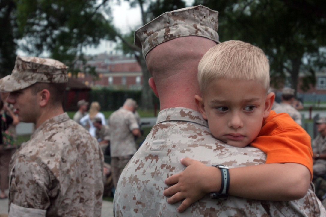 A Marine with the 22nd Marine Expeditionary Unit (Special Operations Capable) shares a final embrace with his son before leaving on deployment from Camp Lejeune, N.C., July 31. The 22nd MEU (SOC) consists of its Ground Combat Element, Battalion Landing Team, 3rd Battalion, 8th Marine Regiment; Aviation Combat Element, Marine Medium Helicopter Squadron 261 (Reinforced); Logistics Combat Element, Combat Logistics Battalion 22; and its Command Element.
