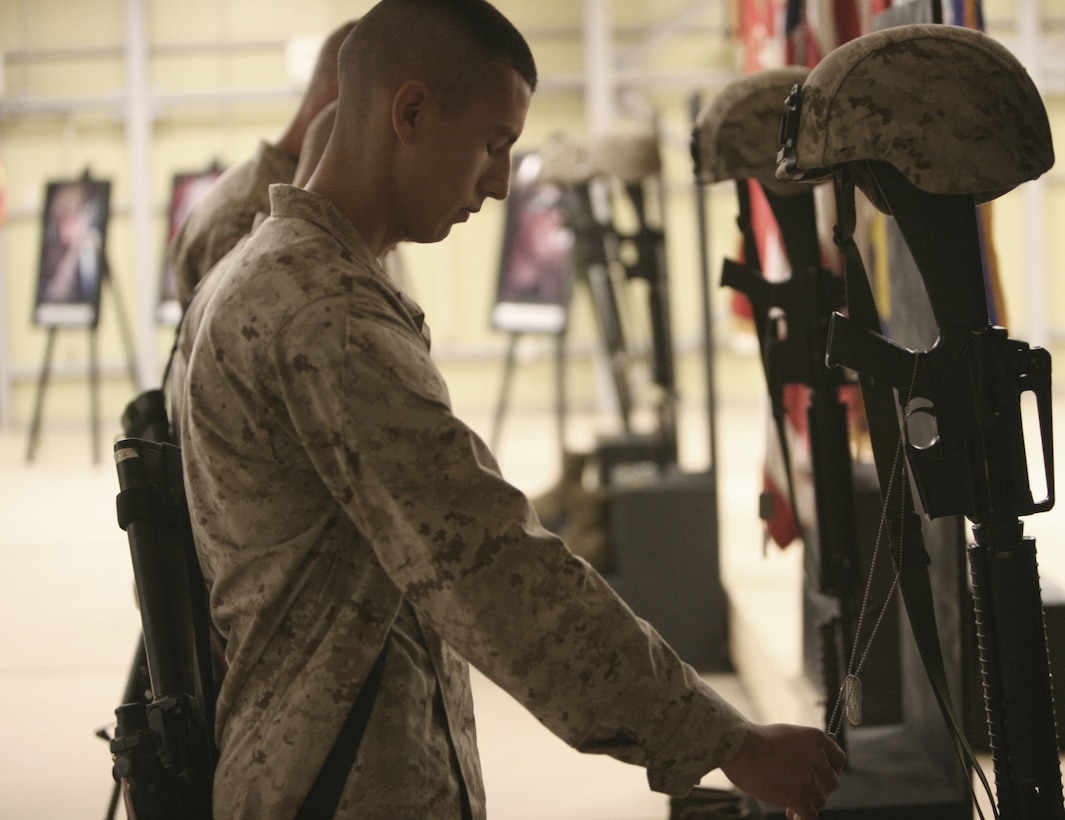 AR RAMADI, Iraq- The Marines of Kilo Battery 3rd Battalion, 12th Marine Regiment mourned four fallen brothers during a memorial ceremony, July 31.  The memorial service honored the lives of Cpl. James H. McRae, Cpl. Matthew R. Zindars, Lance Cpl. Robert A. Lynch, and Hospitalman (FMF) Daniel S. Noble.