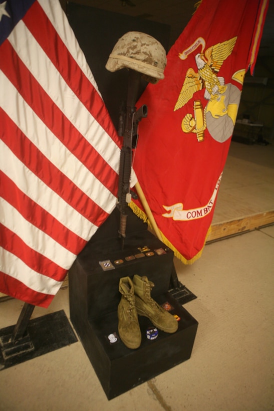 Ar Ramadi, Iraq (August 1, 2007) - Those who gathered paid their respects to the memorial display.  The helmet represents the fallen service member in combat.  The inverted rifle with bayonet represents a time for prayer and a break in the action to pay tribute to their comrade and to take care for the wounded.  The boots represent the final march of the last battle.