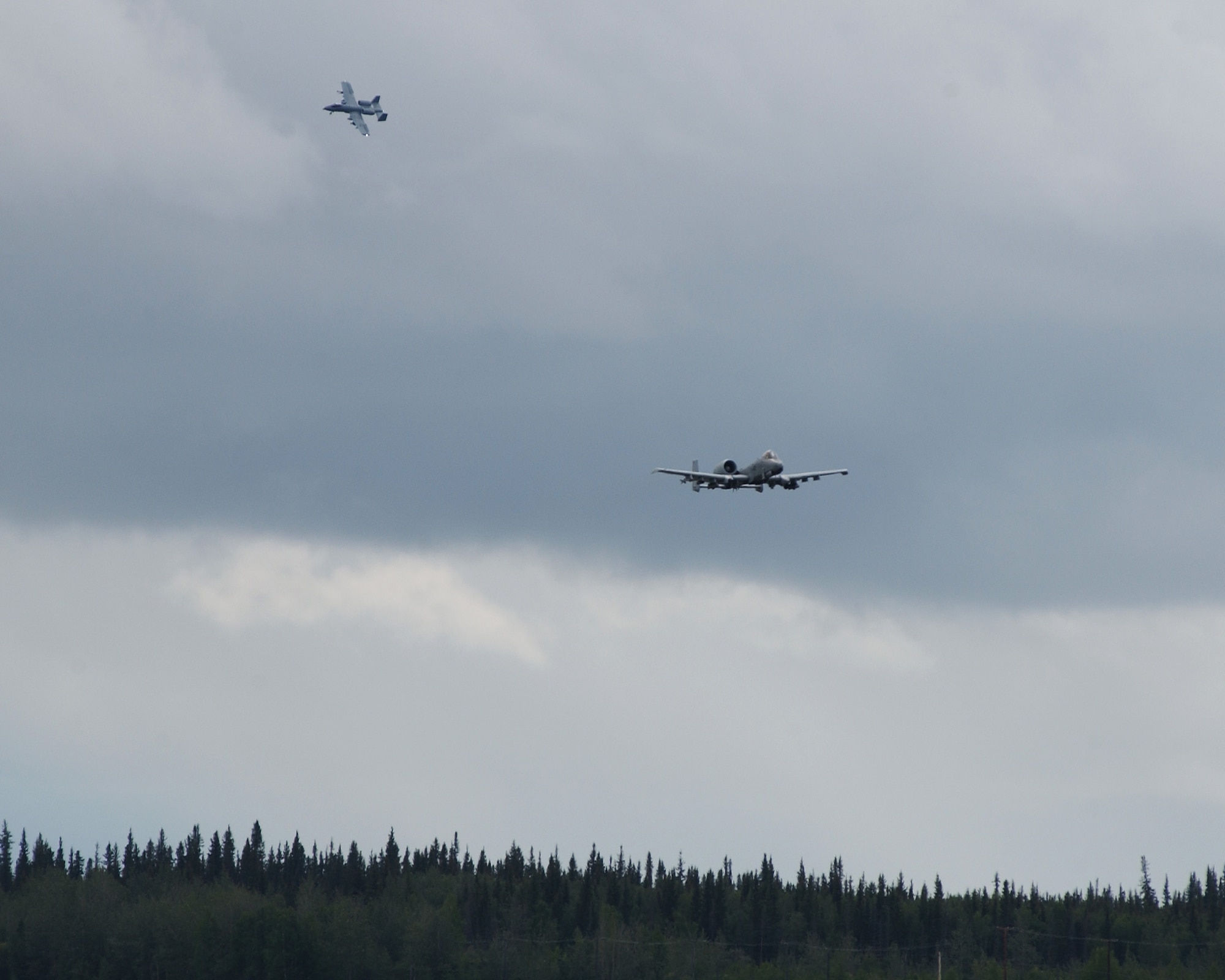 EIELSON AIR FORCE BASE, Alaska -- Two A-10 Thunderbolts from the 355th Fighter Squadron conduct their last flight over the flightline July 31. The first two A-10's arrived at Eielson on December 18, 1981, while the last two A-10's are set to leave on August 15, 2007 to Moody AFB, Ga., and Mountain Home AFB, Idaho (U.S. Air Force Photo by Airman 1st Class Jonathan Snyder)