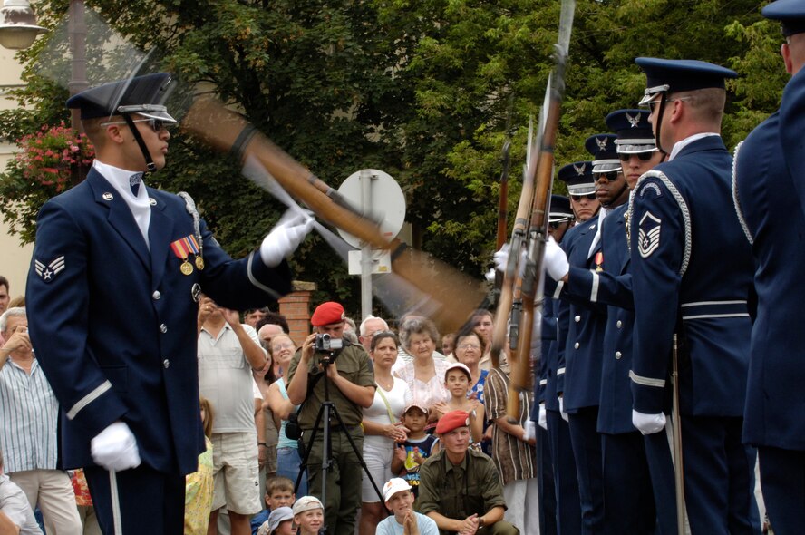 Senior Airman Ruben Chavez, and members of the U.S. Air Force Honor Guard Drill Team, perform their 16-man routine in Szerenes, Hungary 28 July, 2007 as part of the international REGIMENTFEST armed forces showcase.  The Drill Team, the traveling component of the Air Force Honor Guard, is touring five US installations across three countries throughout central Europe this week. The Drill Team tours U.S. Air Force bases/events world wide showcasing the precision of the U.S. Air Force to recruit, retain and inspire Airmen for the U.S. Air Force mission. (U.S. Air Force Photo by Senior Airman Daniel R. DeCook)(Released)