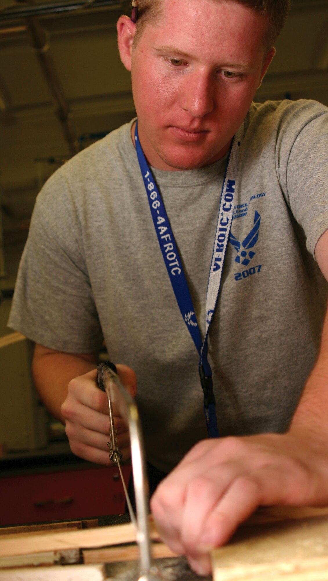 Air Force Junior ROTC Cadet Garrett Tharp saws a piece of wood to use for a frame on his bottle rocket car July 25 during a rocket car construction contest at the University of New Mexico in Albuquerque.  Cadets from Junior ROTC units worldwide visited various science and technology centers as part of the 2007 Air Force Junior ROTC Aerospace and Technology Honor Camps. Approximately 450 cadets attended one of eight camps this year in New Mexico and Oklahoma.  Currently, there are more than 100,000 cadets in the Air Force Junior ROTC program worldwide. (U.S. Air Force photo/Staff Sgt. Jason Lake) 