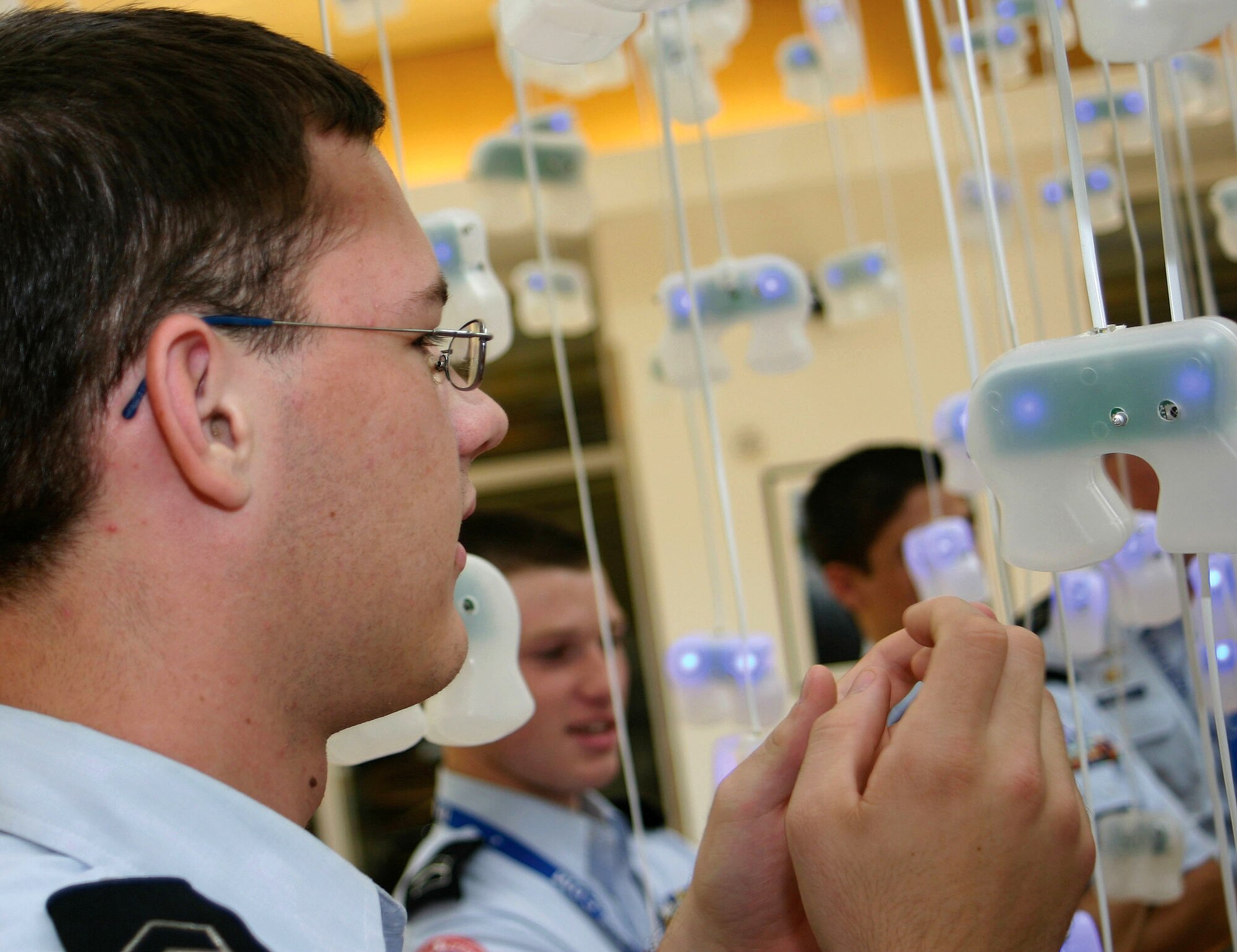 Air Force Junior ROTC Cadet Kevin Ives looks at robotic sensors July 13 developed by engineers at the Stephenson Research and Technology Center at the University of Oklahoma in Norman, Okla.  Cadets from Junior ROTC units worldwide visited the research center and other science and technology centers as part of the 2007 Air Force Junior ROTC Aerospace and Technology Honor Camps. Approximately 450 cadets attended one of eight camps this year in New Mexico and Oklahoma.  Currently, there are more than 100,000 cadets in the Air Force Junior ROTC program worldwide. (U.S. Air Force photo/Staff Sgt. Jason Lake) 