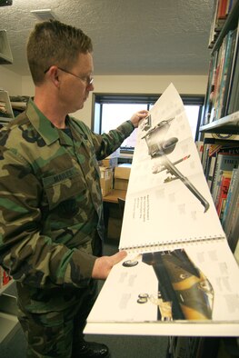 MOUNTAIN HOME AIR FORCE BASE, Idaho -- Master Sgt. Yancy Mailes, 366th Fighter Wing historian, reviews aircraft books at Gowen Field Sept. 2005. Sergeant Mailes will be retiring from the Air Force after 20 years of service only to return to the base as a civilian historian. Starting in 2003, the Air Force began converting its history program from military positions to a fully civilianized force. Sergeant Mailes will be one of the last enlisted historians to convert to a civilian position. (U.S. Air Force photo/Senior Airman Sergio Aguirre)