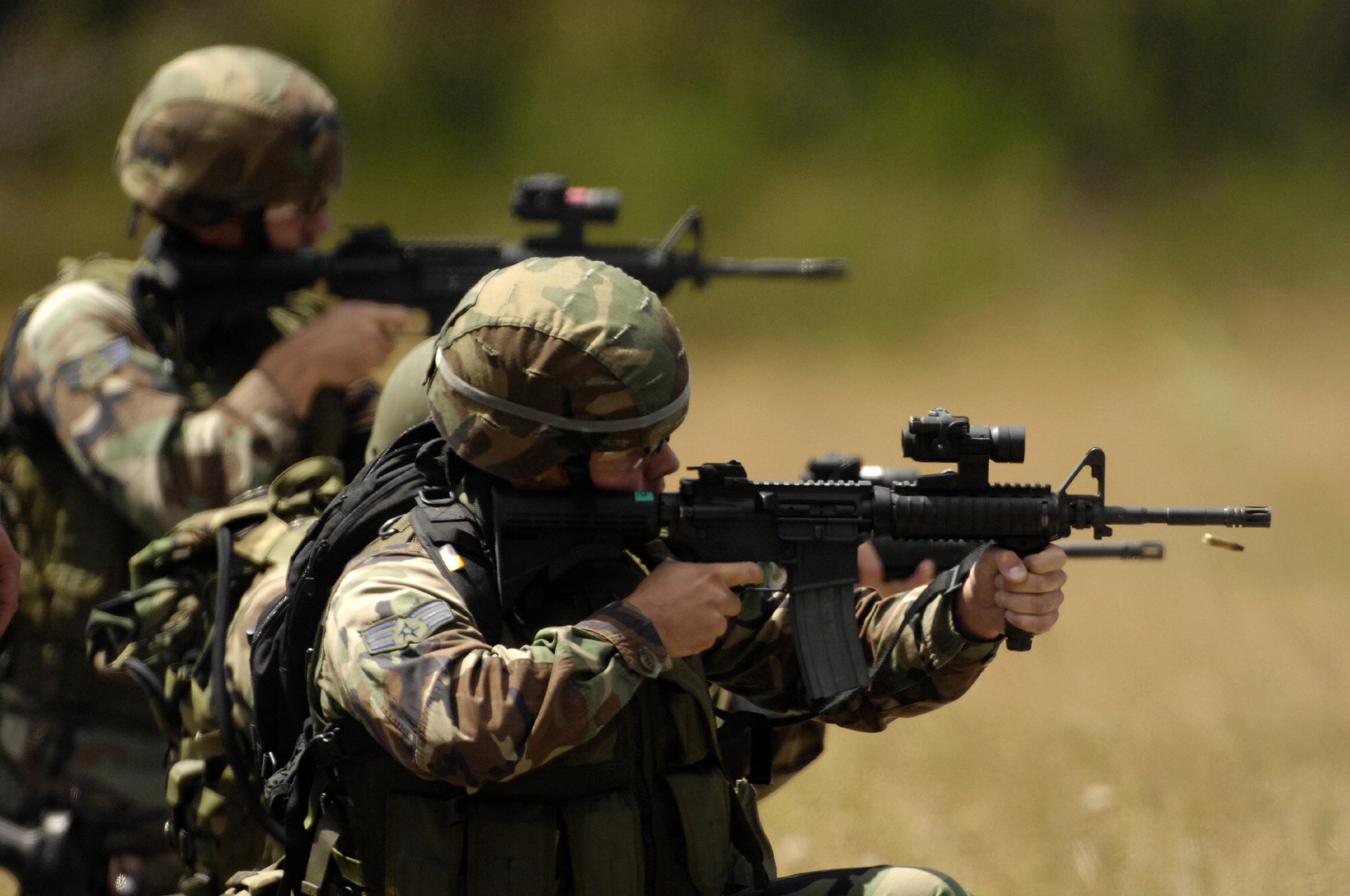 FORT LEWIS, Wash. –Airmen from 92nd Security Forces Squadron, Fairchild Air Force Base, Wash., fire M-4 assault rifles in the combat weapons competition during Air Mobility Command's Rodeo 2007 here July 24. The three-man SFS team from Fairchild won the Best Combat Tactics Team competition. Team members were Staff Sgt. Levi Wilson and Senior Airmen David Jones and Lonnie Bell. Rodeo is a readiness competition of U.S. and international mobility air forces and focuses on improving warfighting capabilities. (U.S. Air Force photo by Staff Sgt. Samuel Bendet)