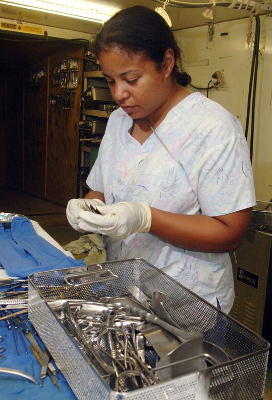 Tech. Sgt. Rose Noches sets up equipment for an exploratory laparotomy procedure at Balad Air Base, Iraq. Sergeant Noches is a granddaughter of 1st Lt. Ramon F. Noches, a Tuskegee Airman killed in a B-25G aircraft accident June 6, 1945, during night-flying training from Gunter Army Air Field at Montgomery, Ala. Sergeant Noches is a surgical service craftsman with the 332nd Expeditionary Medical Group and a living legacy to the Tuskegee Airmen of World War II fame. She is deployed from Lackland Air Force Base, Texas. (U.S. Air Force photo/Staff Sgt. Gerard Anthony Sabido) 