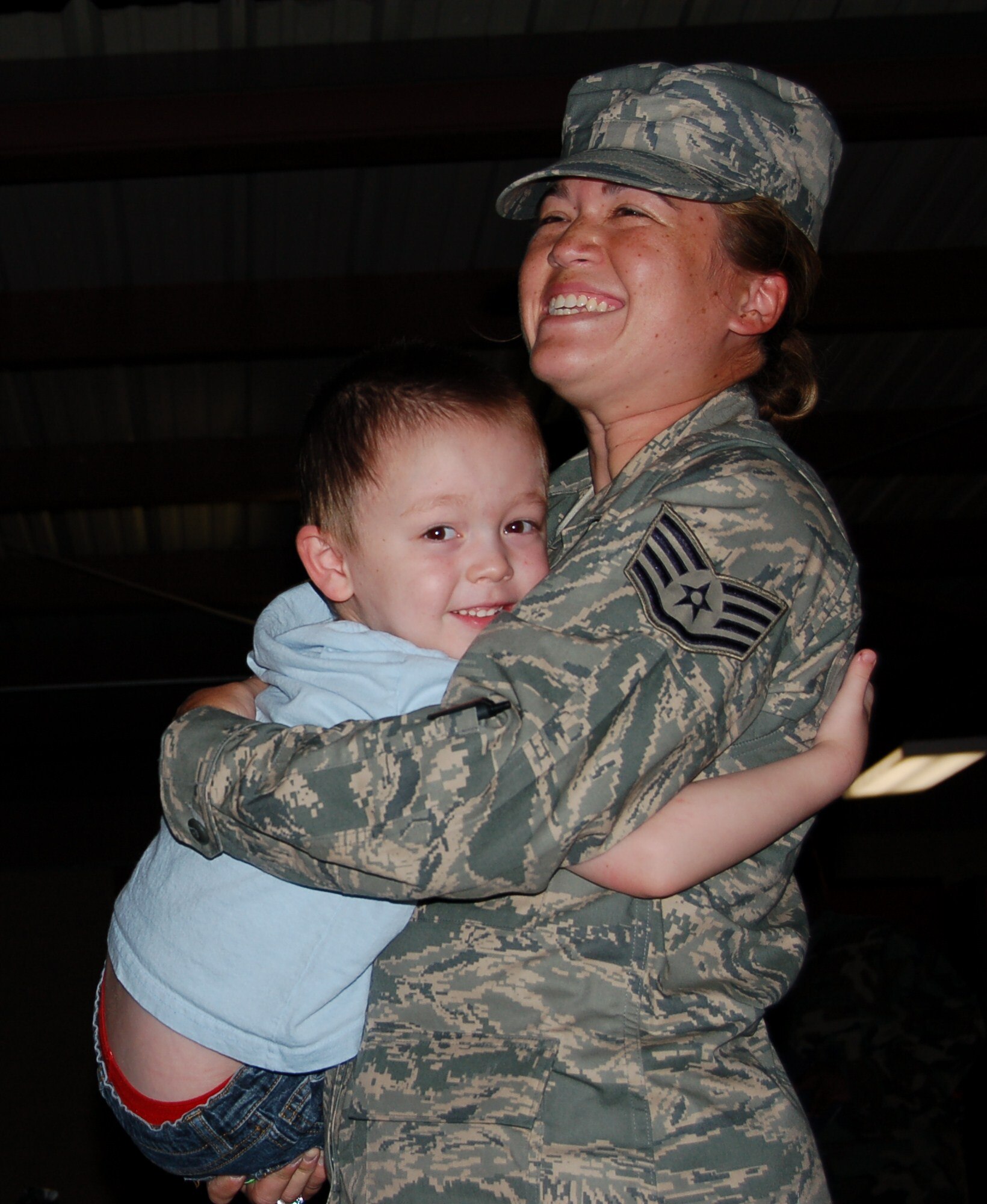 Staff Sgt. Katherine Sikes, 49th Security Forces Squadron, holds her son, Joseph, before departing Holloman Air Force Base July 31 on a six month deployment to Kuwait. Approximately 30 Airmen from the squadron will be sent to Kuwait International Airport as part of Operation Iraqi Freedom. This will be Sergeant Sikes sixth deployment. (Photo by U.S. Air Force Capt. Warren A. Comer)