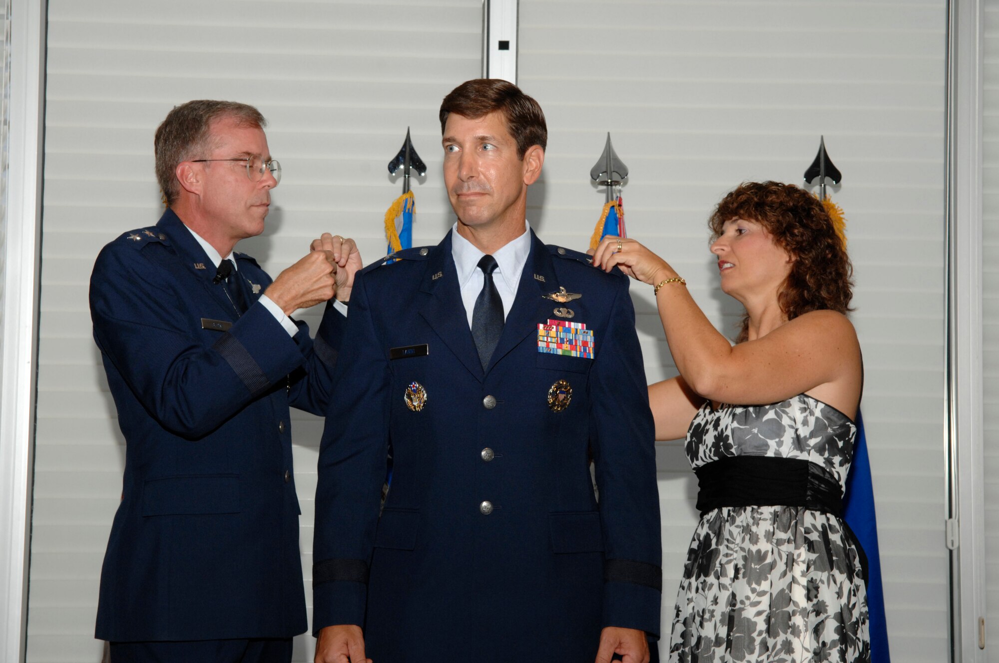 EGLIN AIR FORCE BASE, Fla. -- Maj. Gen. Curtis Bedke, Air Force Flight Test Center commander, Edwards Air Force Base, Calif., and Pam Lanni, pin on the rank of brigadier general on Brig. Gen. Joseph A. Lanni, Air Armament Center vice commander, during a ceremony at the Eglin Officers' Club Aug. 27. More than 300 friends and family members joined the Lanni family to celebrate the achievement. (U.S. Air Force photo by Craig McDonnell)