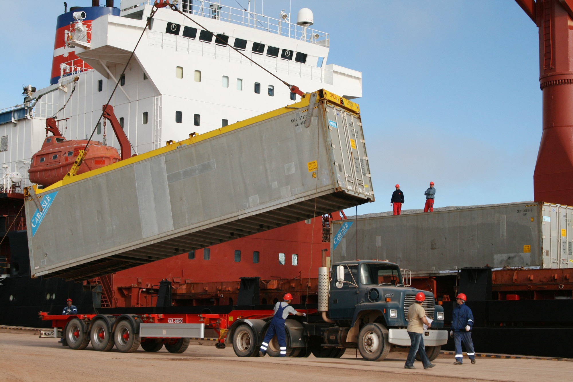 Crews unload the American Tern at Thule’s port. More than four feet of ice in the harbor during the winter forces the base to bring in nearly a year’s worth of supplies during the short summer months. (U.S. Air Force photo)